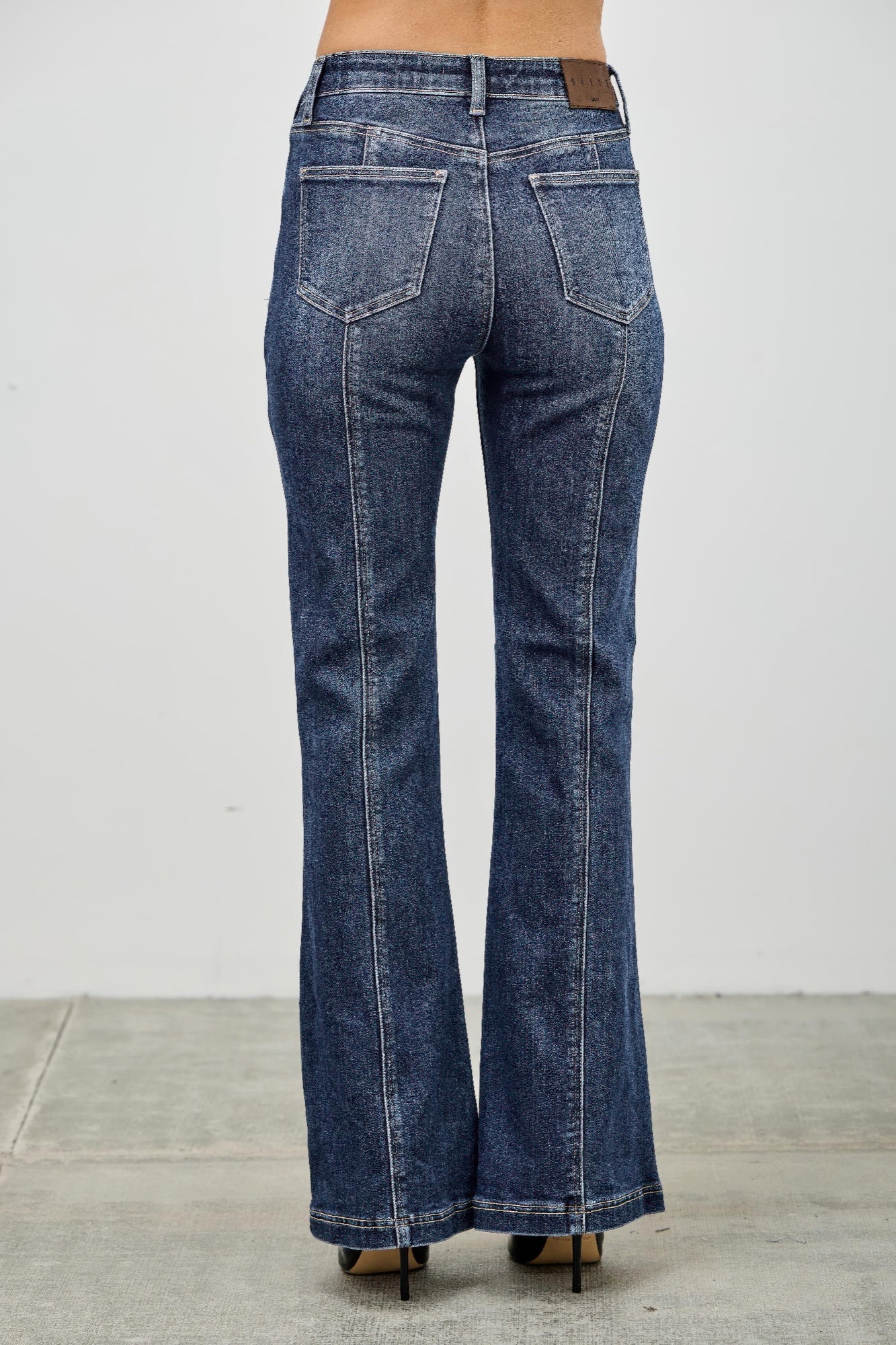 Toshe Women's Fashions high rise boot cut jeans with seam detail, showcasing a stylish fit and classic denim design.