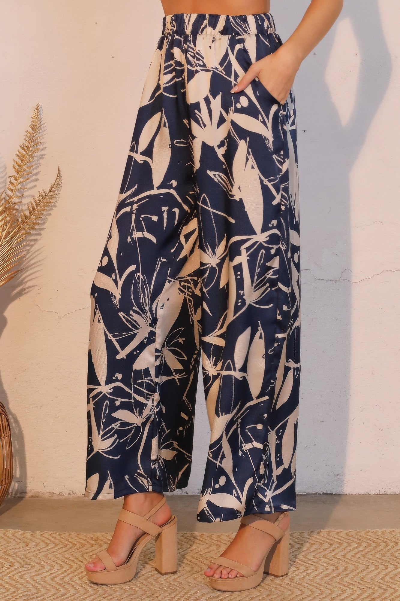 Satin pocket pants from Toshe Women's Fashions with a relaxed fit, featuring side pockets and a sleek, shiny finish.