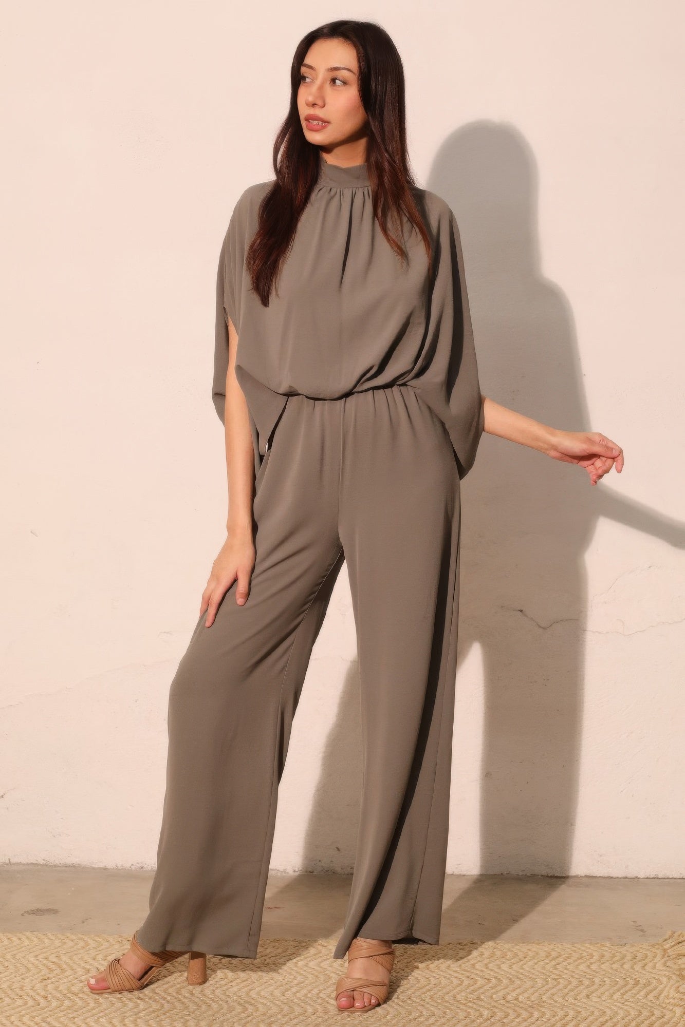 Textured solid mock neck caftan jumpsuit by Toshe Women's Fashions, featuring a relaxed fit and wide-leg silhouette.