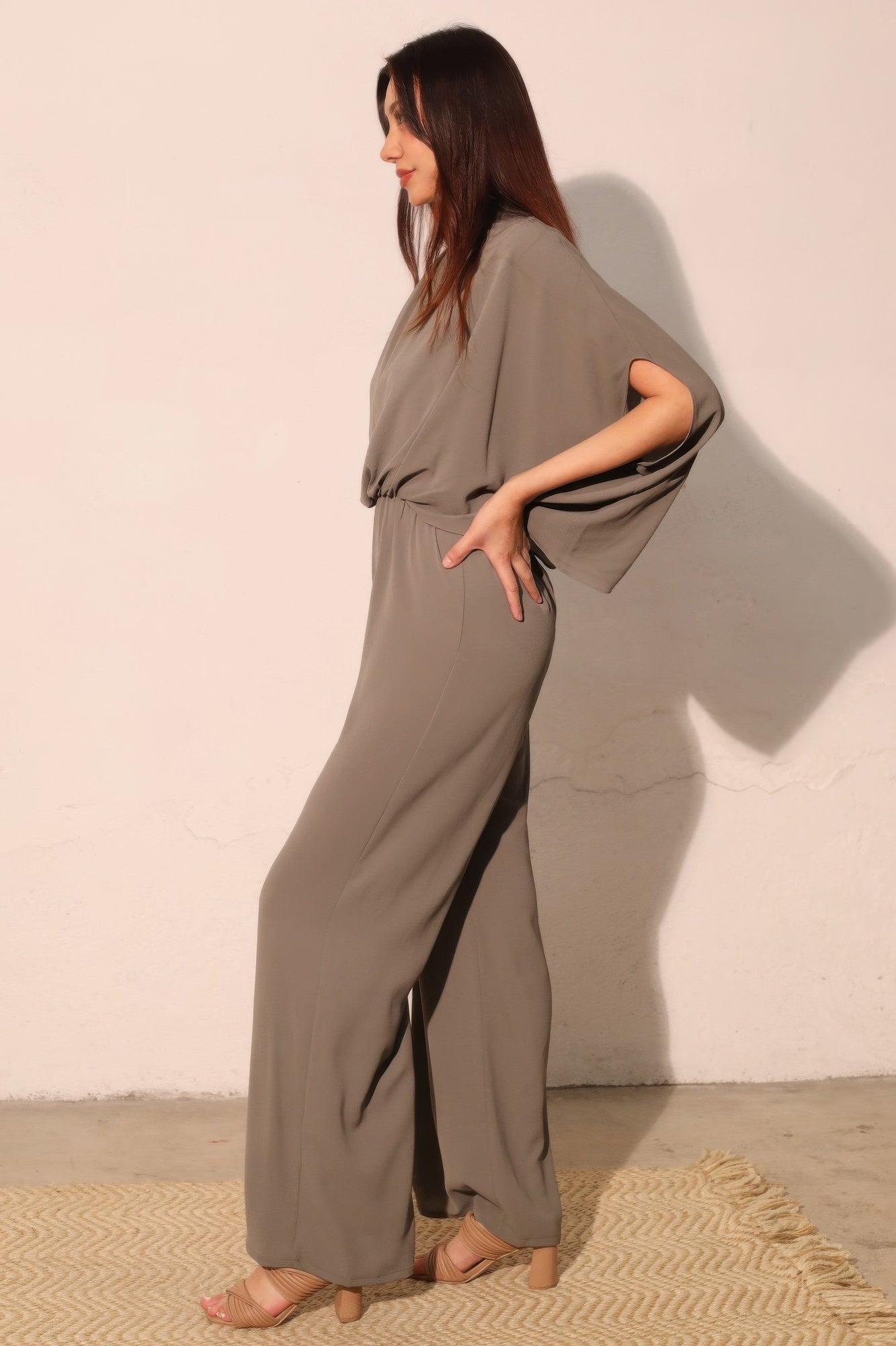 Textured solid mock neck caftan jumpsuit by Toshe Women's Fashions, featuring a relaxed fit and stylish design.
