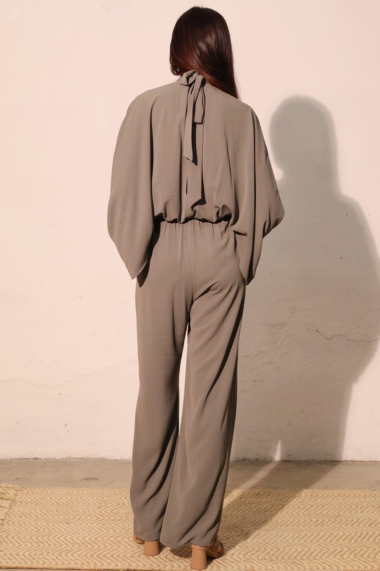 Textured solid mock neck caftan jumpsuit by Toshe Women's Fashions, featuring wide-leg design and relaxed fit.
