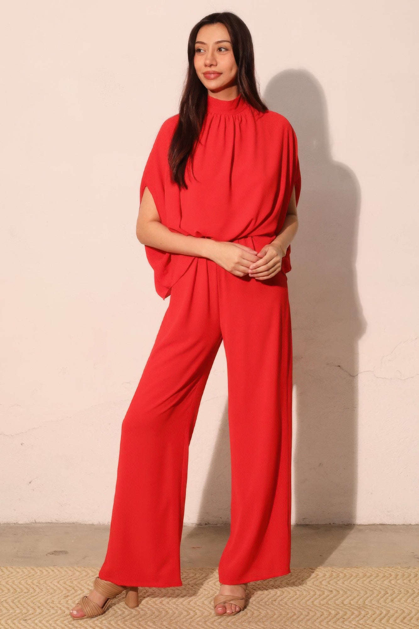Textured solid mock neck caftan jumpsuit from Toshe Women's Fashions, displayed on a mannequin with flowing fabric and relaxed fit.
