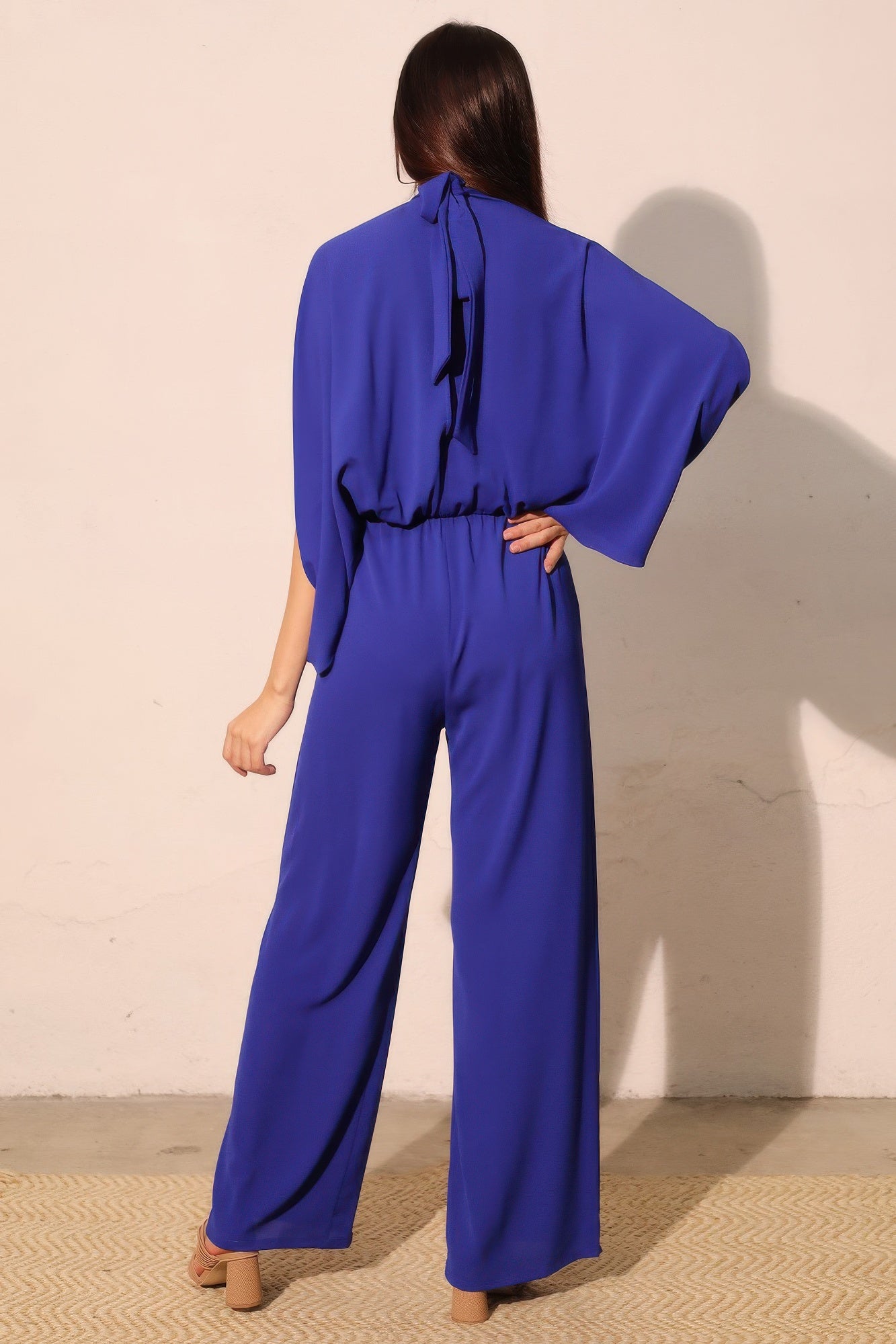 Textured solid mock neck caftan jumpsuit by Toshe Women's Fashions, featuring a relaxed fit and stylish design.