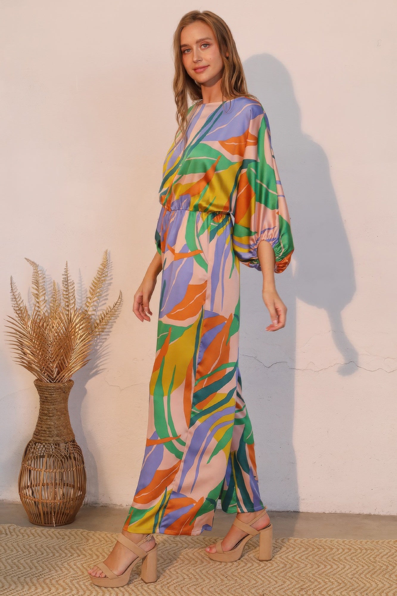 Toshe Women's Fashions Isla Tropical satin boat neck blouson jumpsuit with relaxed fit and vibrant tropical print.