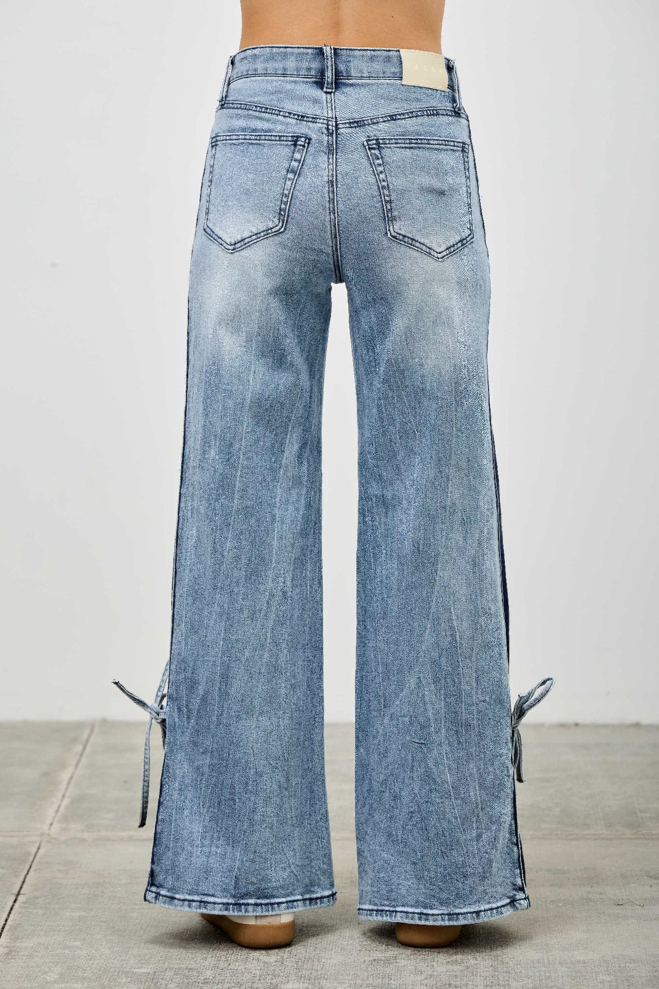 Mid-rise contrast wide-leg pants with side leg tie from Toshe Women's Fashions, shown on a model.