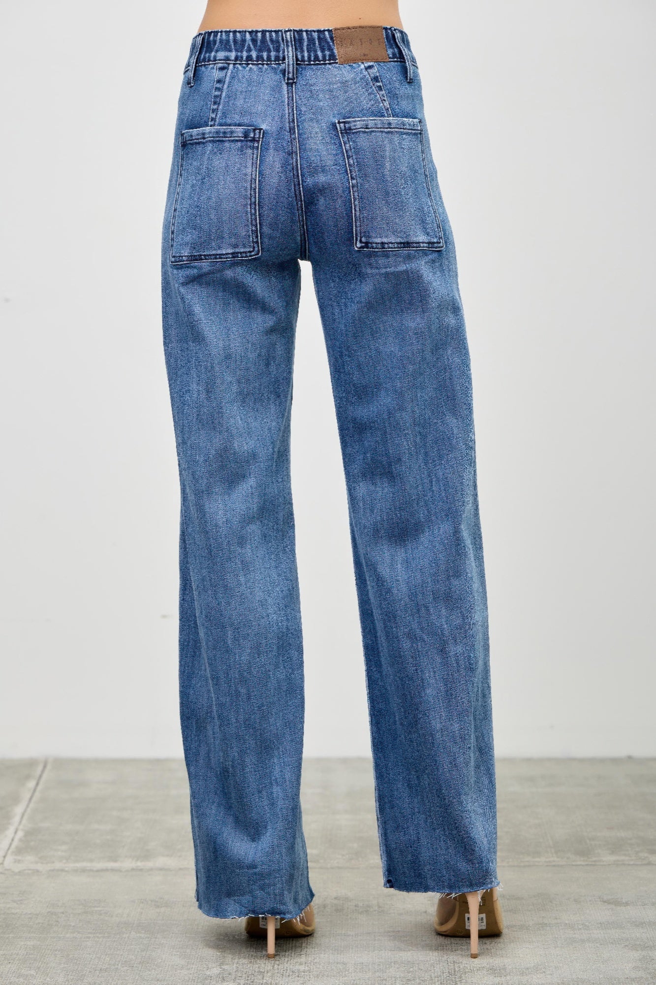 Toshe Women's Fashions high rise straight jeans with front line detailing, shown on a model.