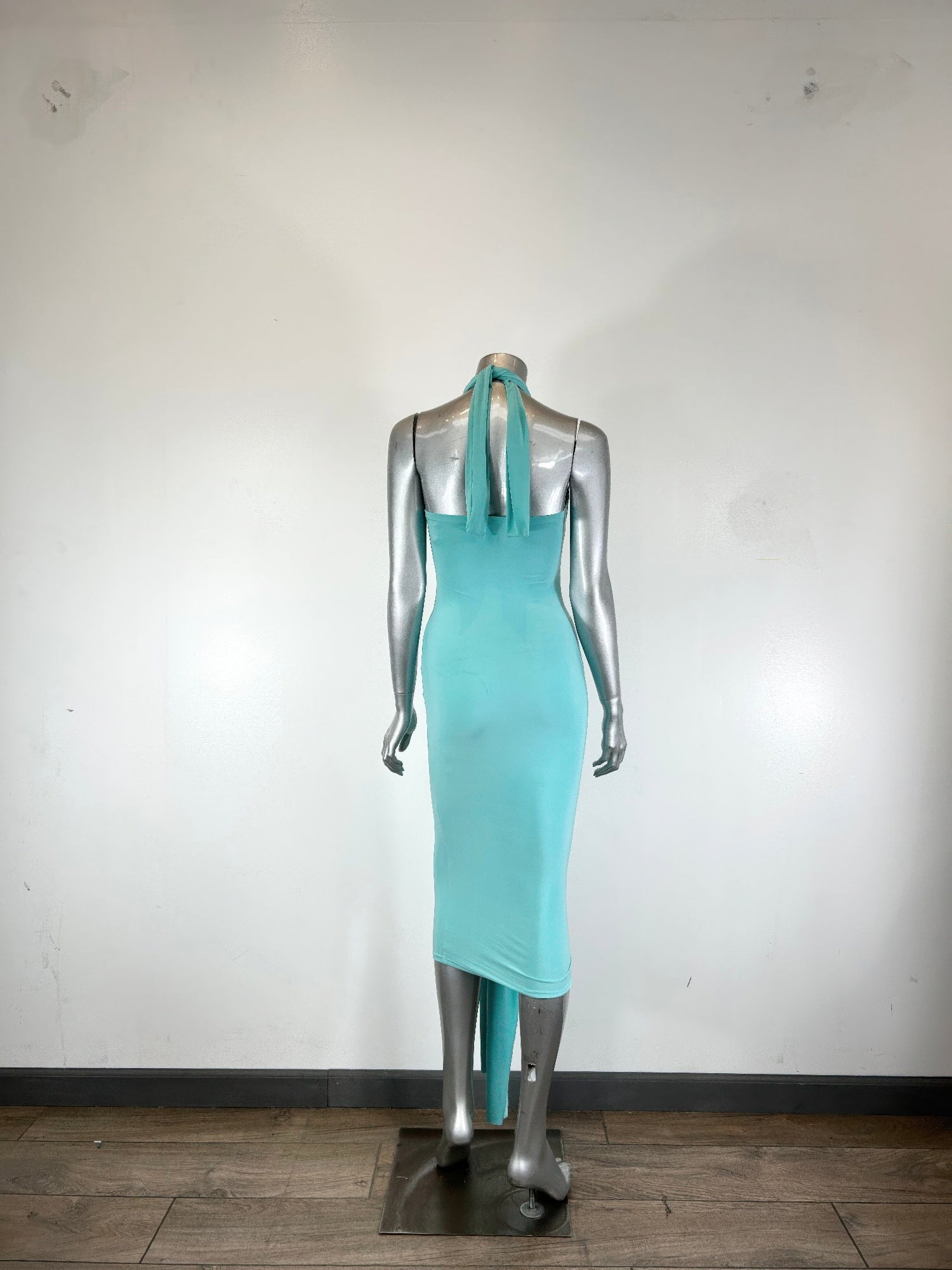 Halter-style bodycon midi dress by Toshe Women's Fashions, fitted design, sleeveless with a sleek silhouette, shown on a model.