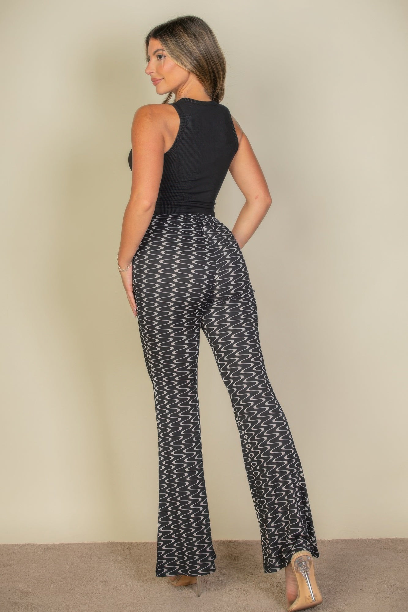 Wavy print high waist flare pants by Toshe Women's Fashions, featuring a stylish wavy pattern and wide-leg design.