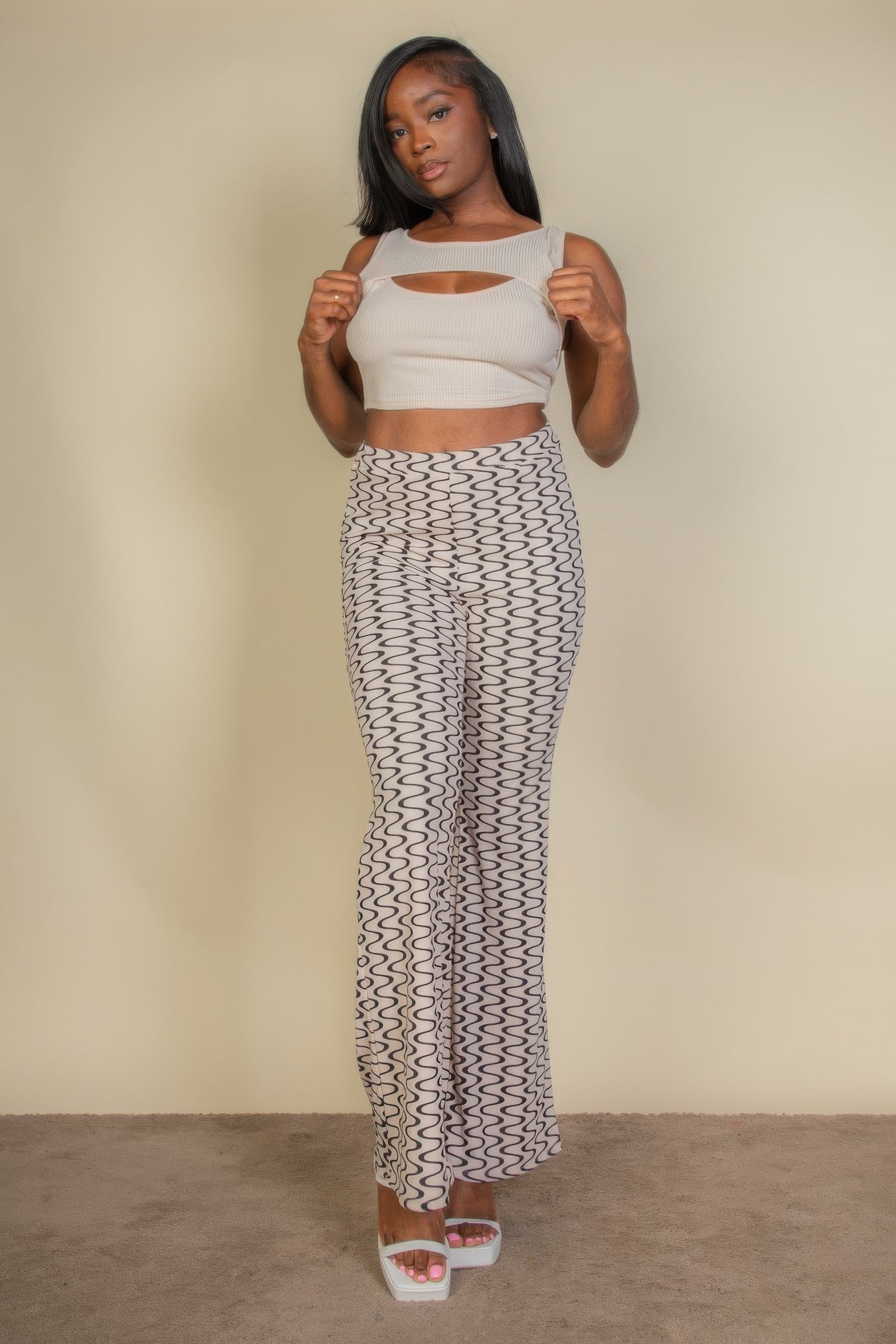 Wavy print high waist flare pants from Toshe Women's Fashions featuring a vibrant wavy pattern and wide-leg silhouette.