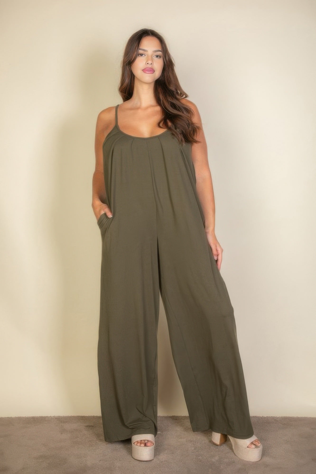 Toshe Women's Fashions spaghetti strap solid wide jumpsuit displayed on a hanger, featuring a relaxed fit and wide leg design.