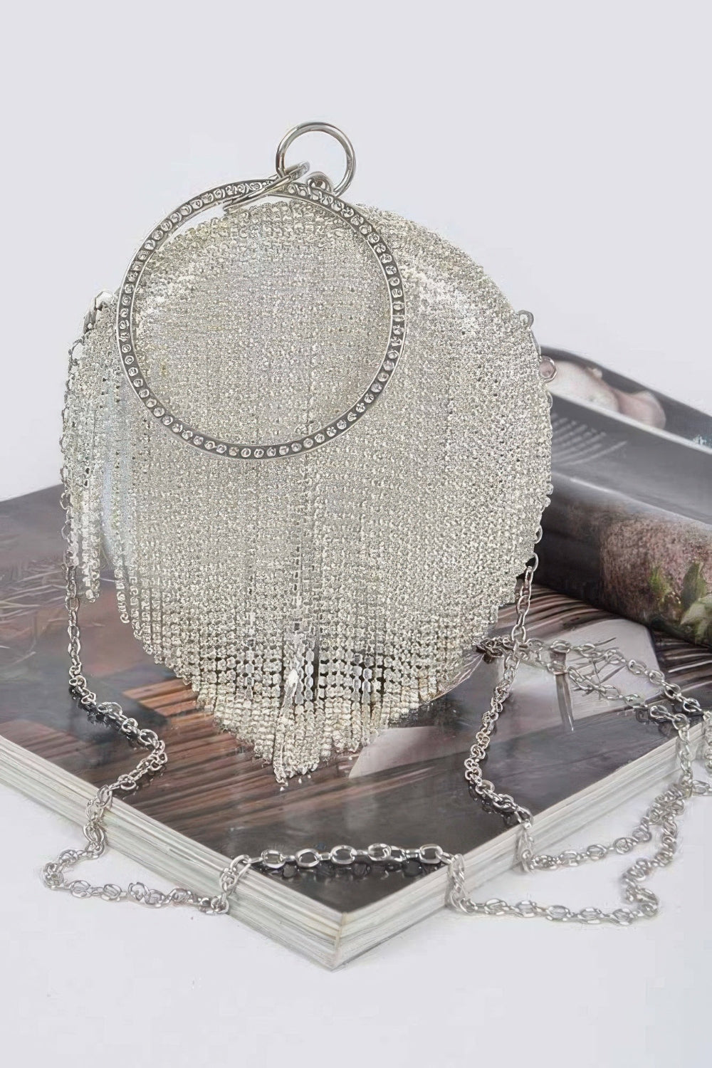 Rhinestone fringe round party bag with glittering embellishments, designed for evening events and special occasions.