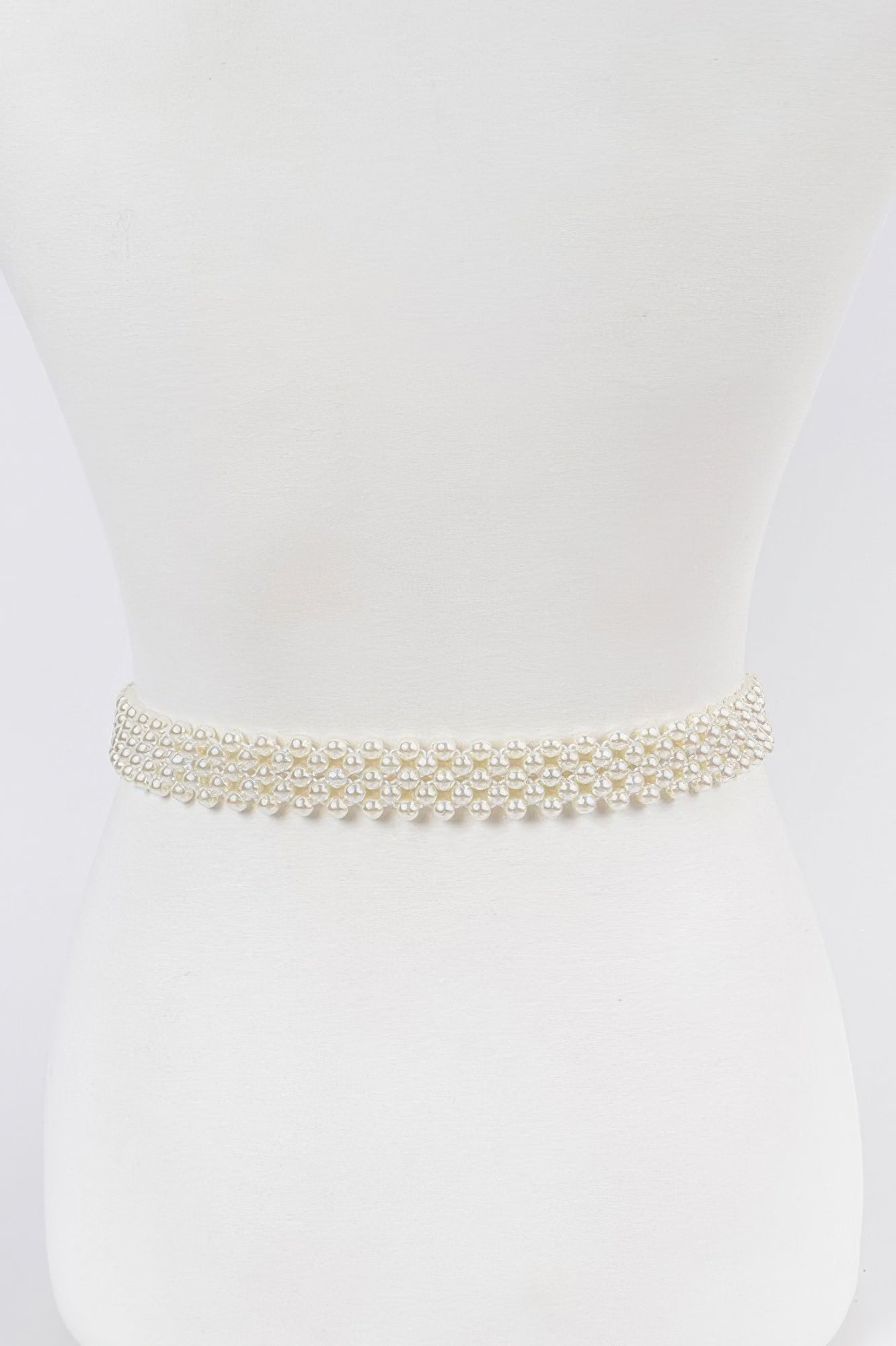 Elastic pearl belt from Toshe Women's Fashions featuring a stretch fabric and pearl accents for a stylish accessory.
