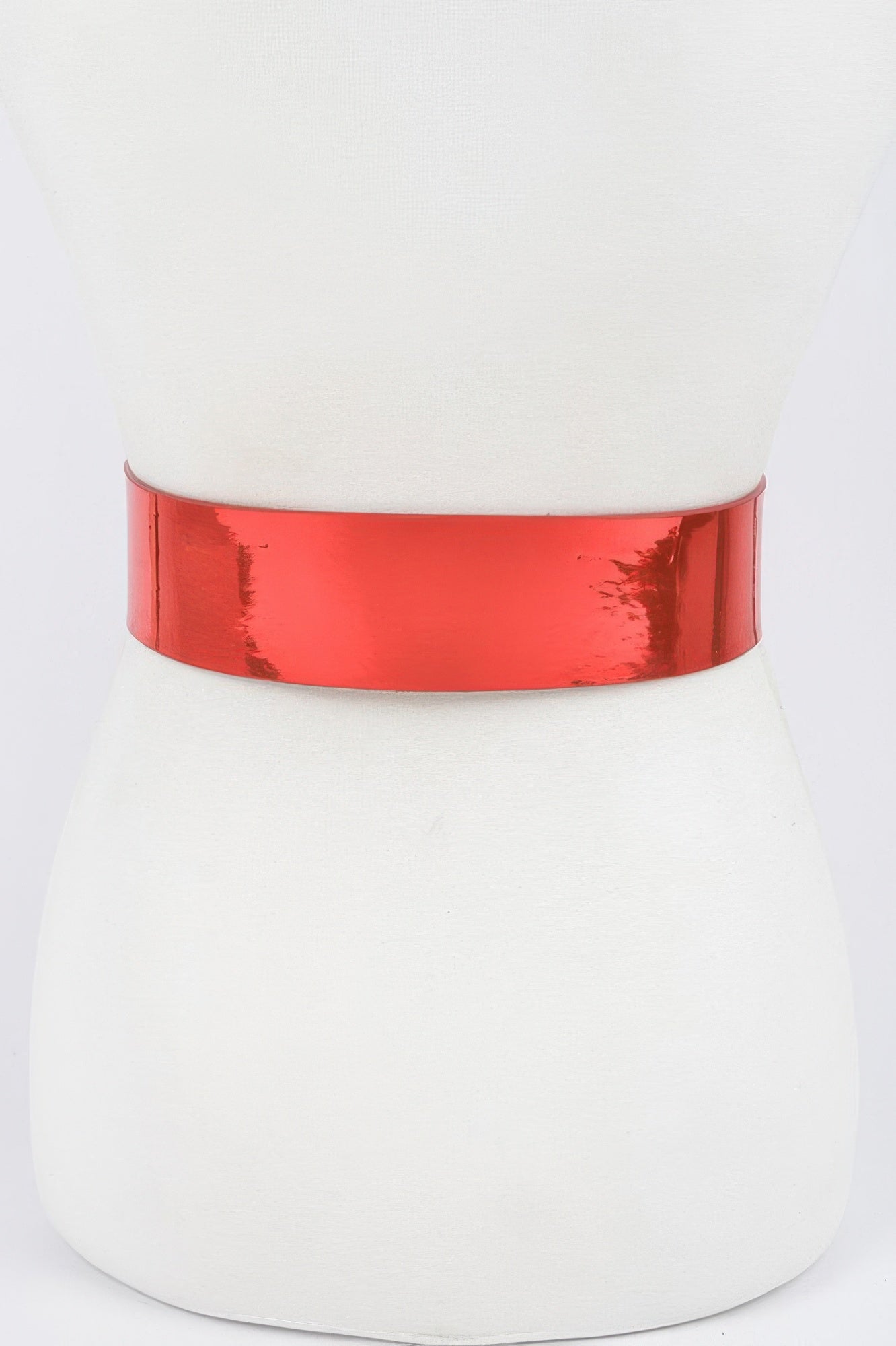 Metallic wide belt from Toshe Women's Fashions displayed on a neutral background, showcasing its shiny finish and wide design.
