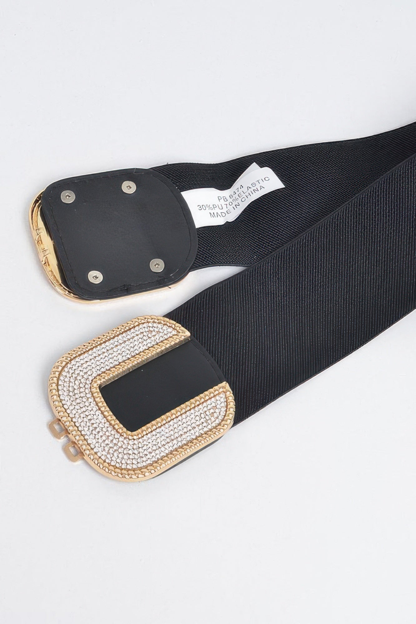 Rhinestone C-buckle stretch belt from Toshe Women's Fashions, featuring sparkling rhinestones and a sleek C-shaped buckle.