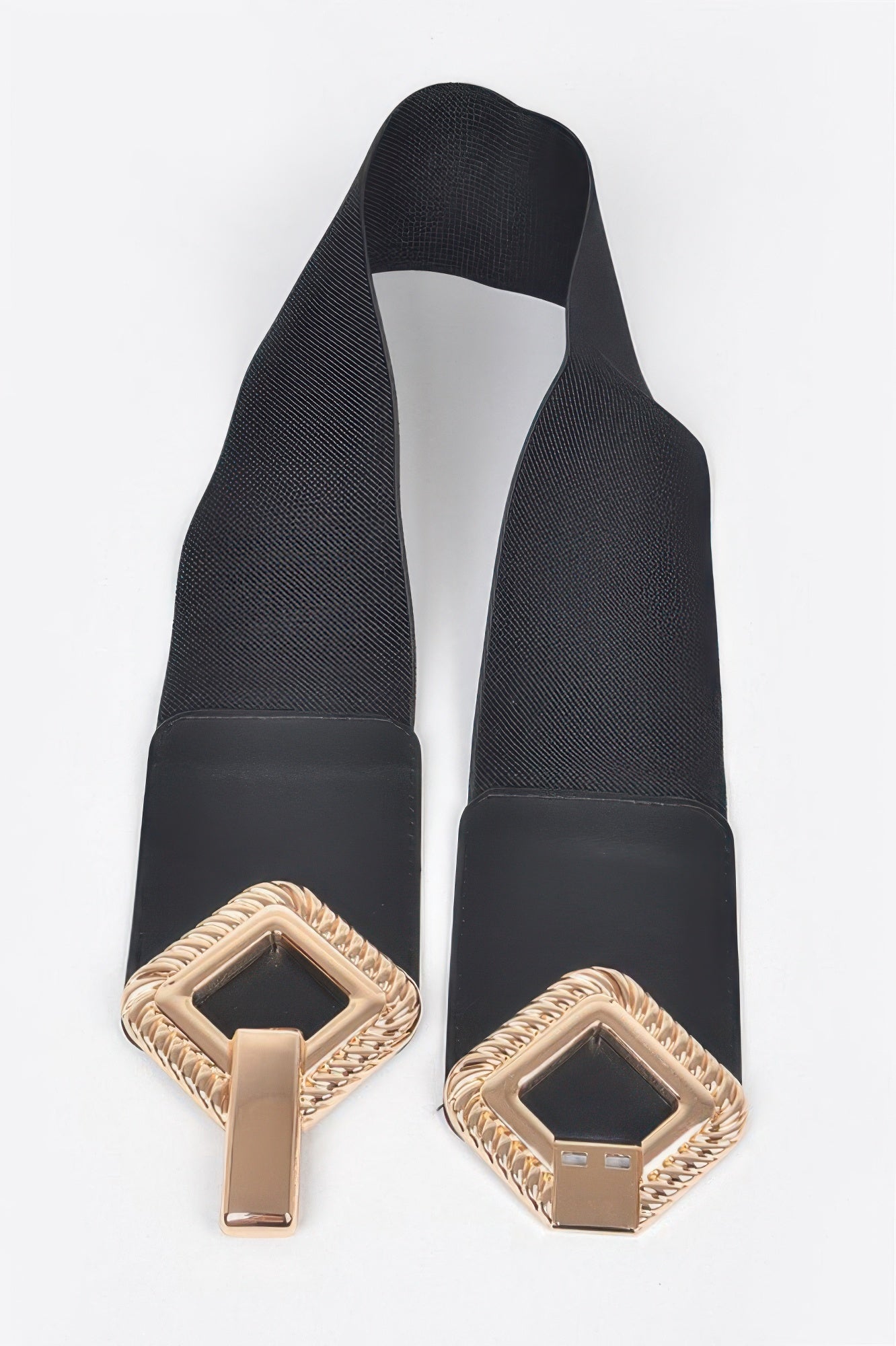 Big metal buckle stretch belt by Toshe Women's Fashions showing a sleek leather strap with a bold metal buckle.