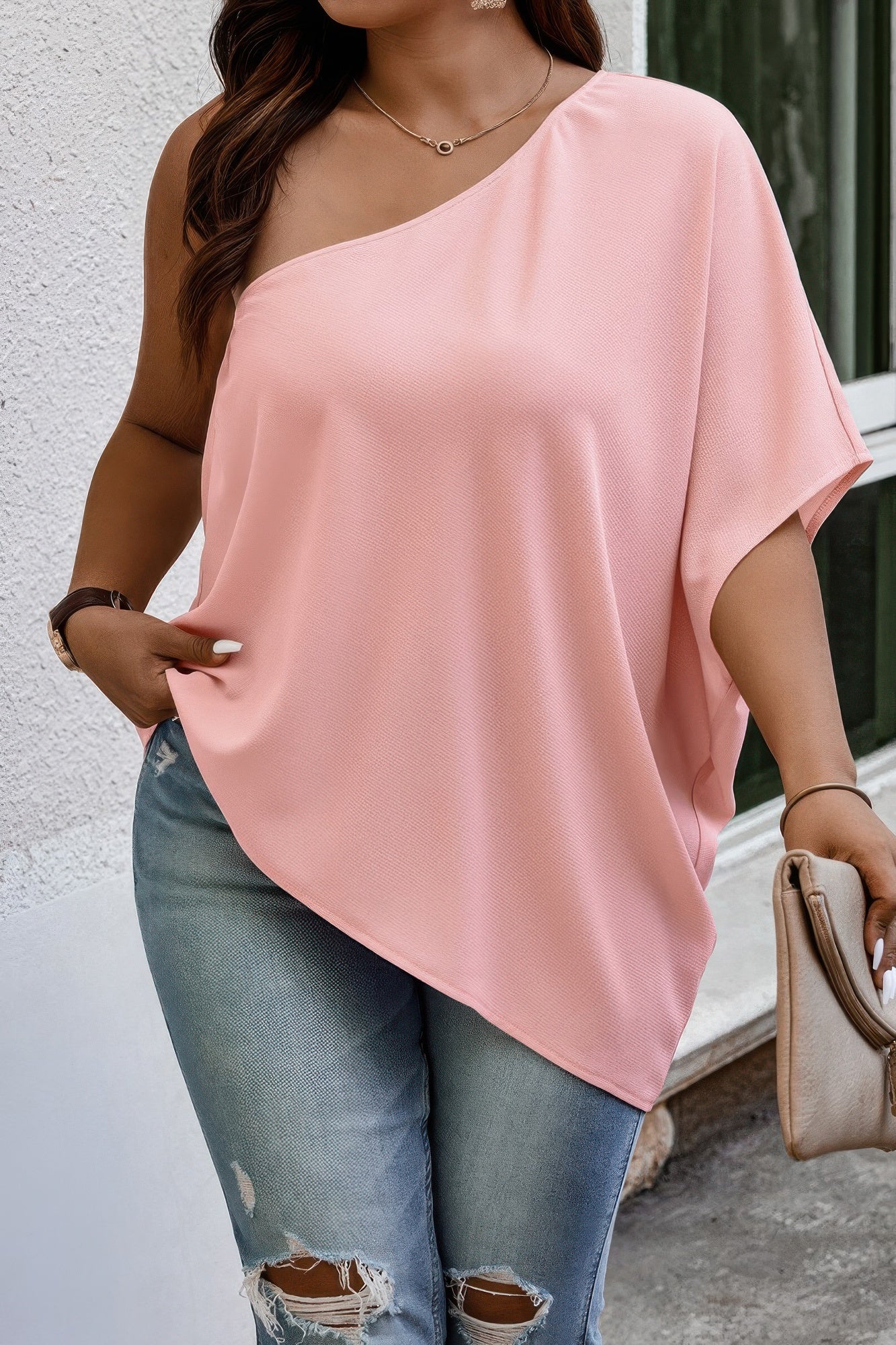 Loose fit one shoulder shirt by Toshe Women's Fashions, shown in a stylish, relaxed fit on a model.