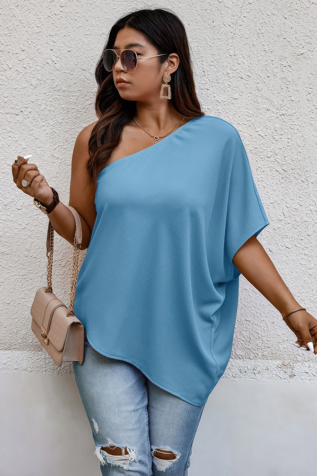 Loose fit one shoulder shirt by Toshe Women's Fashions, shown in a relaxed style with draped fabric and casual silhouette.