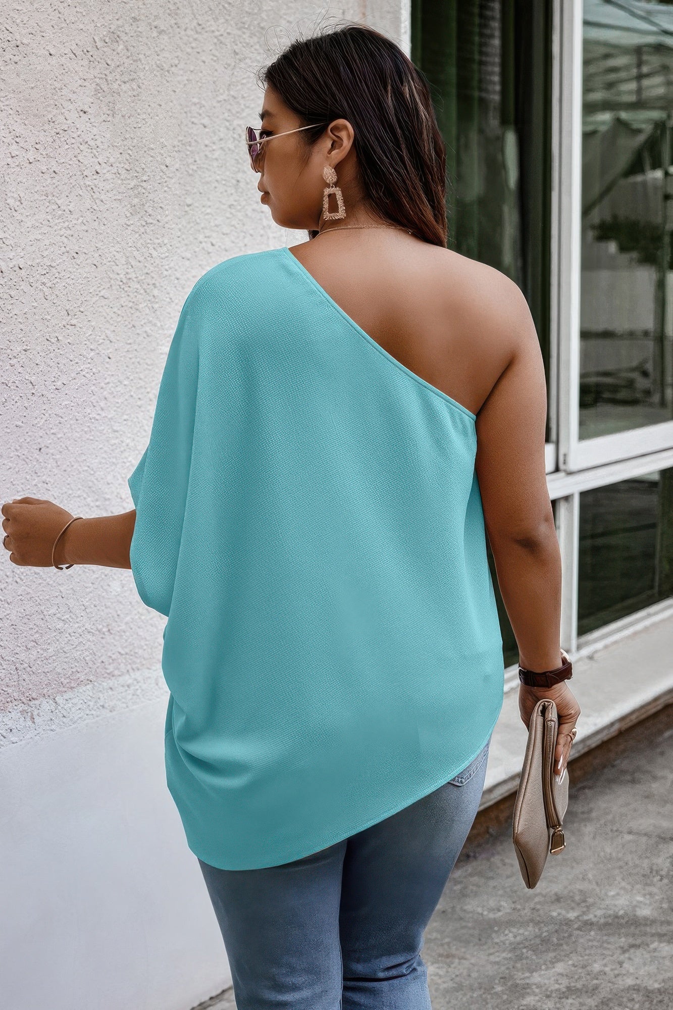 Loose fit one-shoulder shirt by Toshe Women's Fashions featuring a relaxed style and casual design.