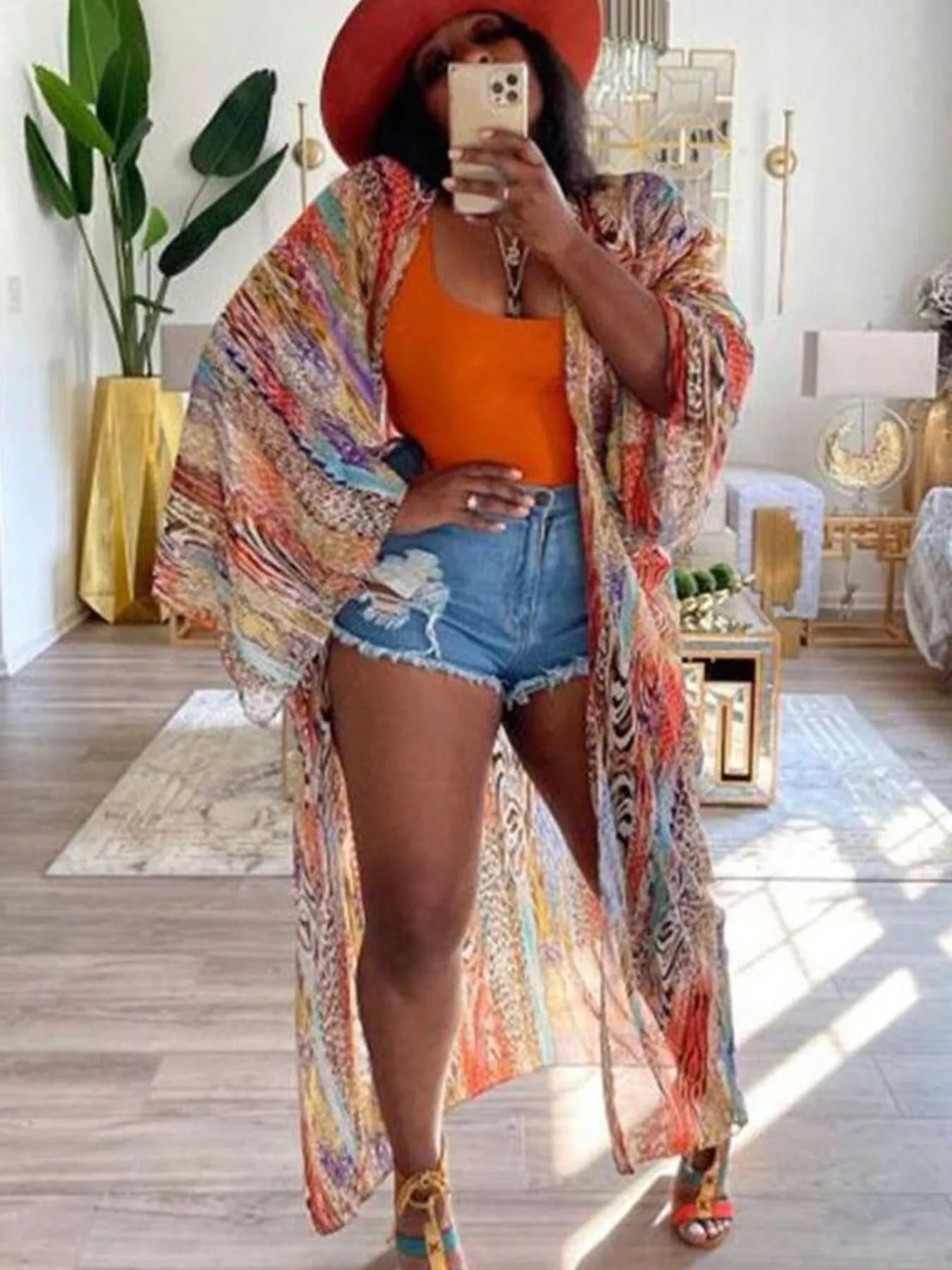 Bohemian orange print flowy cardigan from Trendsi, featuring lightweight fabric and relaxed fit with vibrant boho-inspired design.