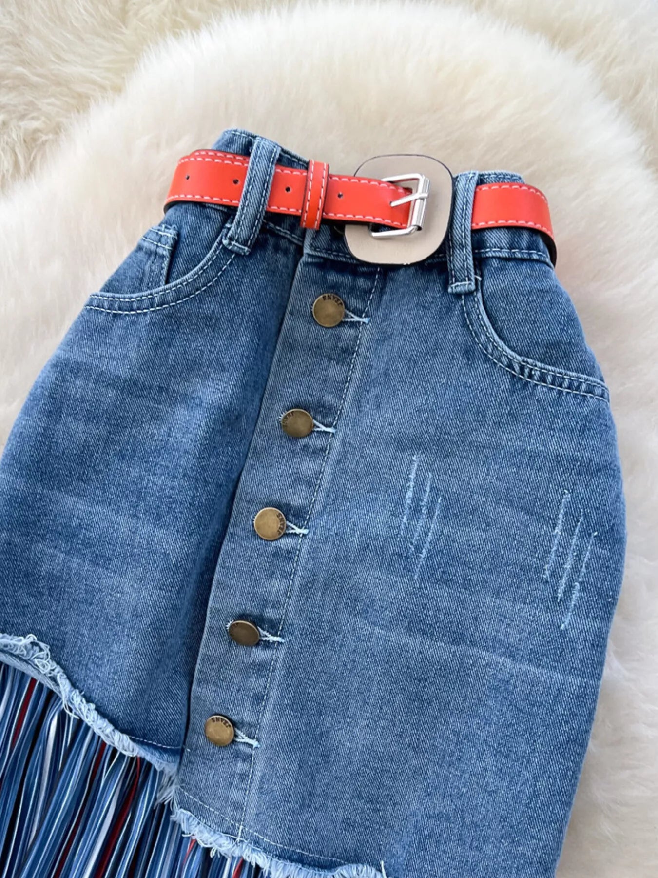 Striped patchwork denim skirt from Trendsi, showcasing a stylish, multicolored design with a classic denim texture.