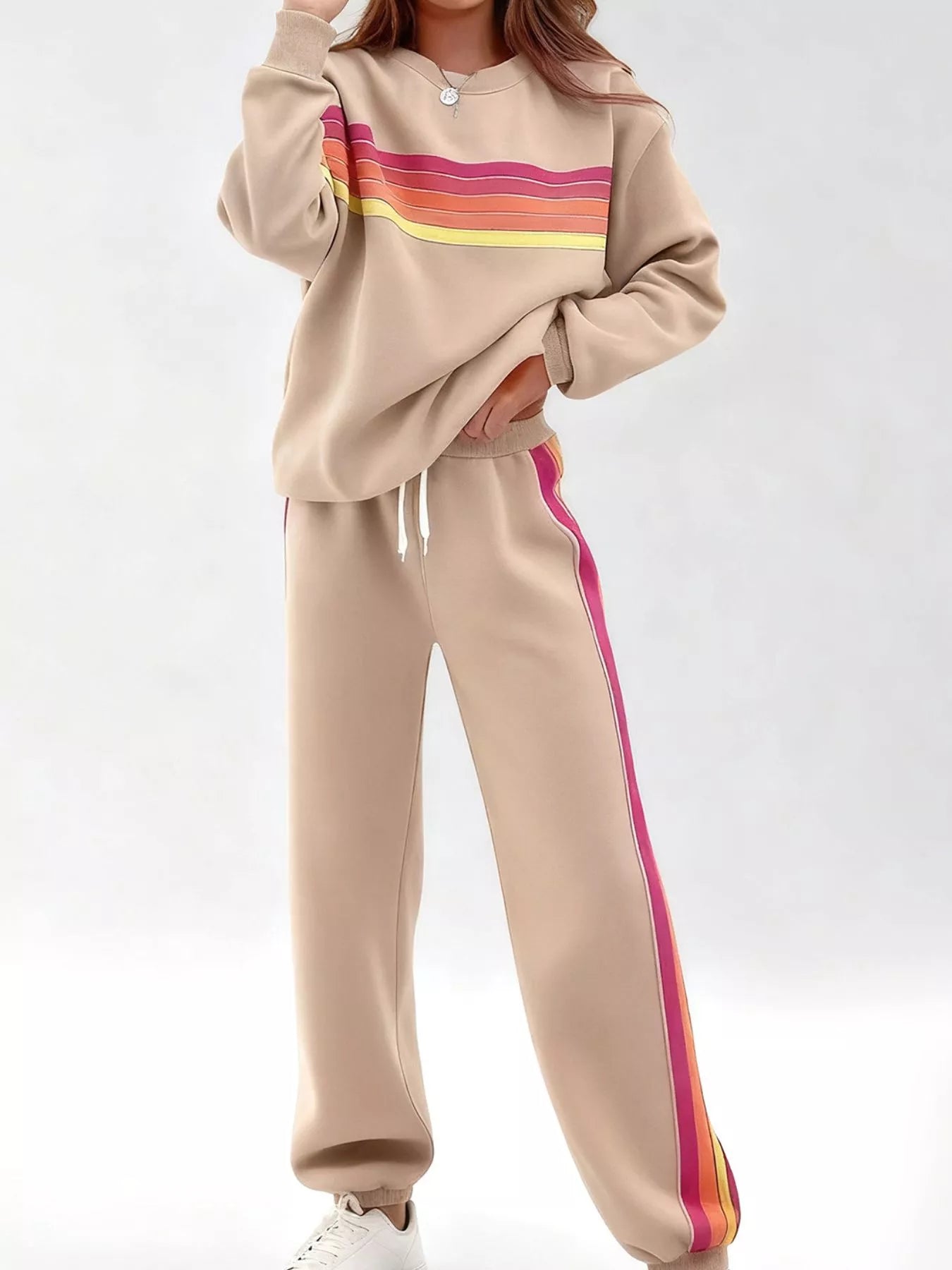 Striped round neck sweatshirt and pants set by Trendsi, featuring a casual, comfortable design with bold stripe patterns.