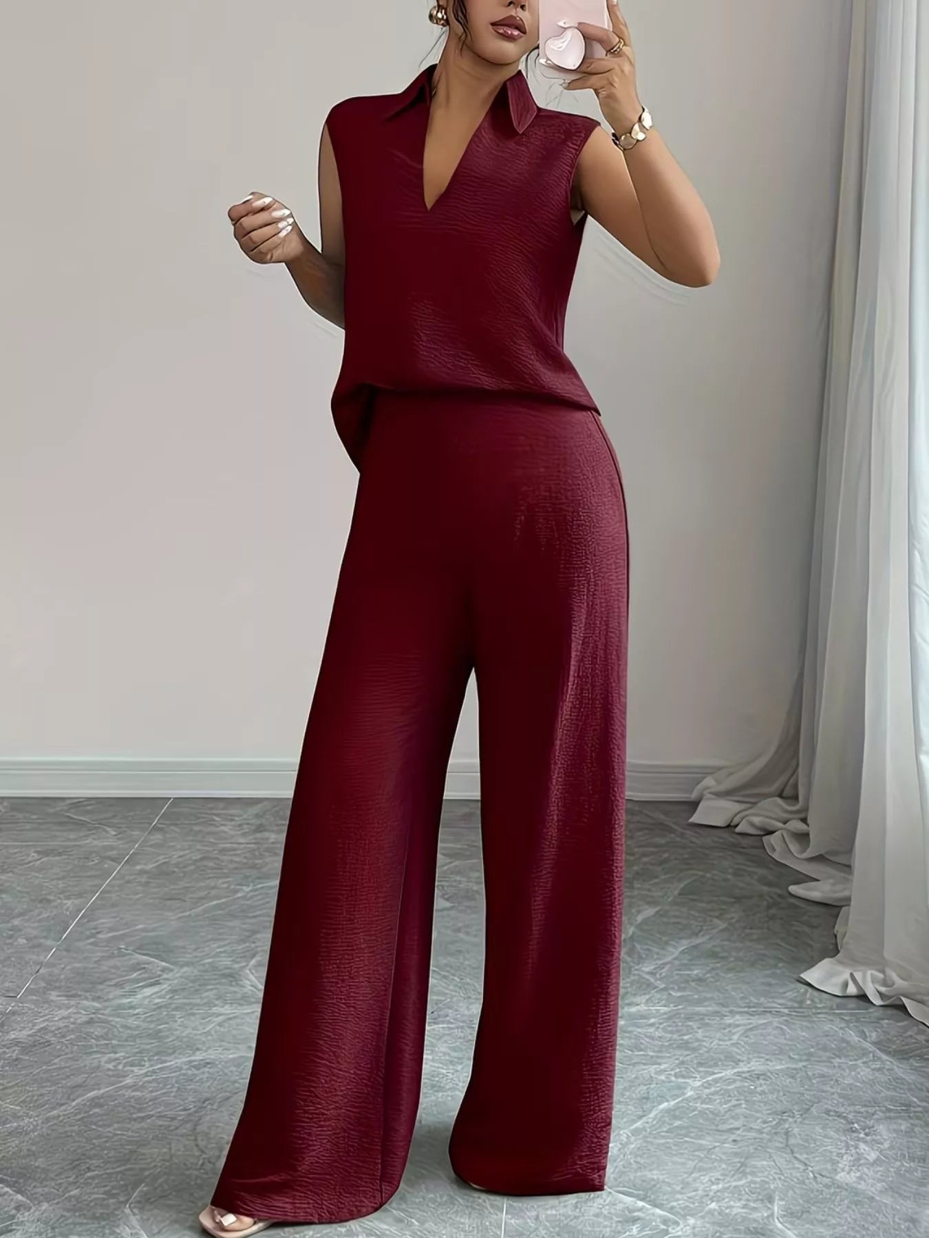 V-neck sleeveless top and wide-leg pants set by Trendsi, featuring a stylish V-neck, sleeveless design, and flowing wide-leg trousers.
