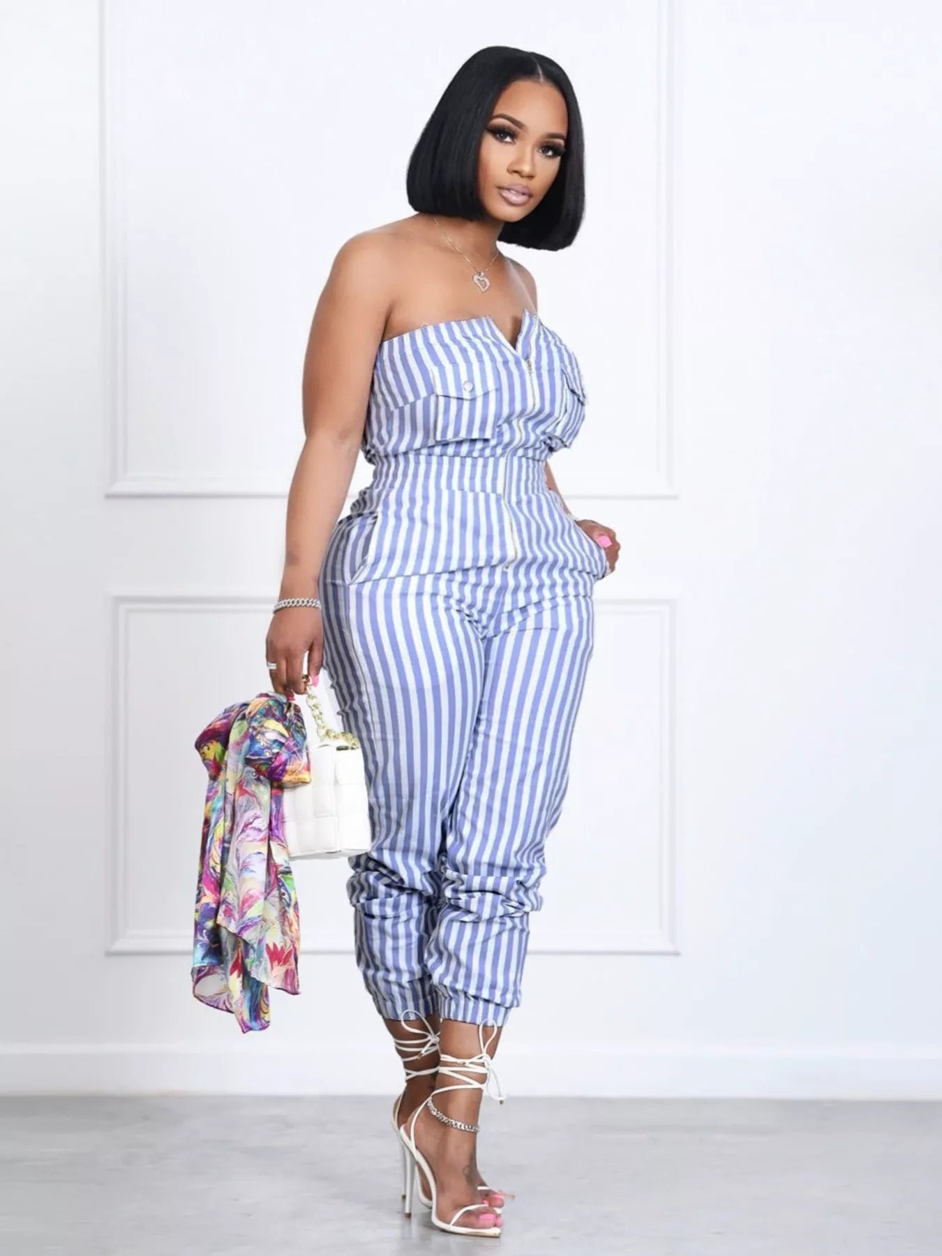 Striped tube jumpsuit by Trendsi, featuring a fitted design with bold vertical stripes and sleeveless style.