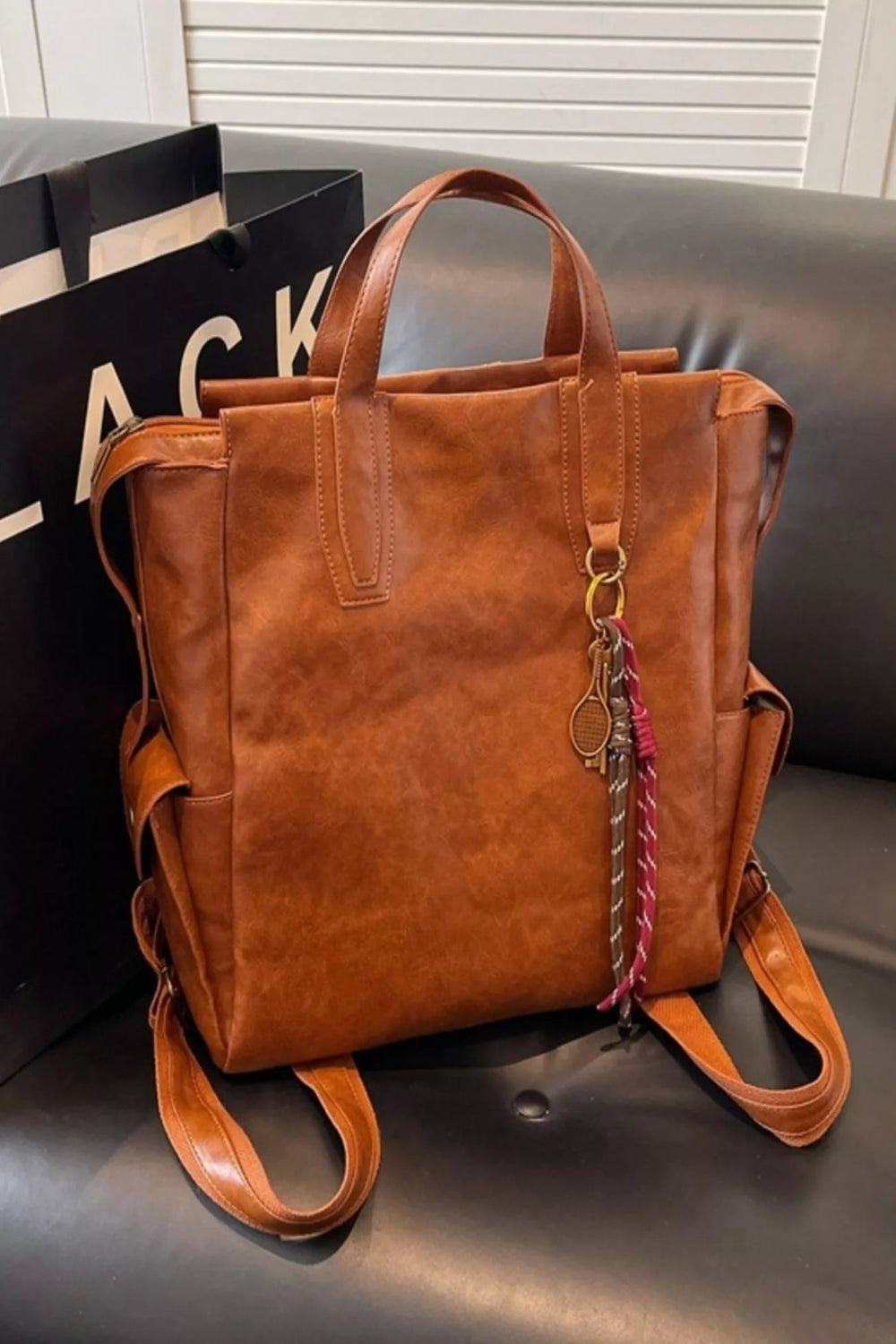 Vintage leather convertible backpack bag by Trendsi, showing a stylish brown leather backpack with adjustable straps and a top handle.