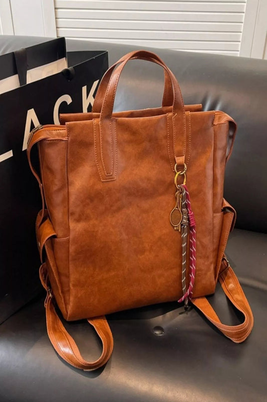 Vintage leather convertible backpack bag by Trendsi, showing a stylish brown leather backpack with adjustable straps and a top handle.