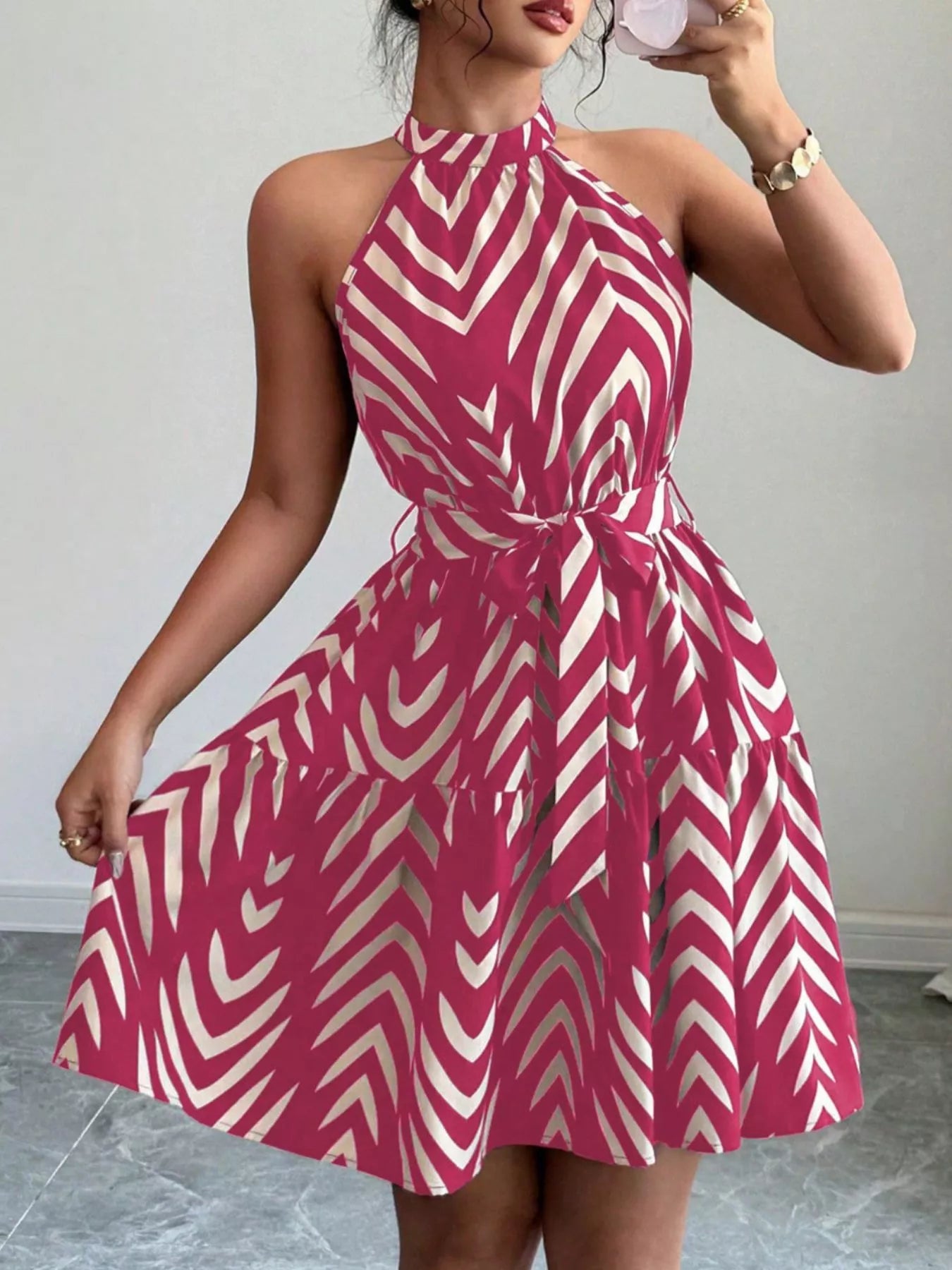 Zebra print halter neck dress with tie waist and ruffle hem, stylish trendy dress by Trendsi, shown on a model.