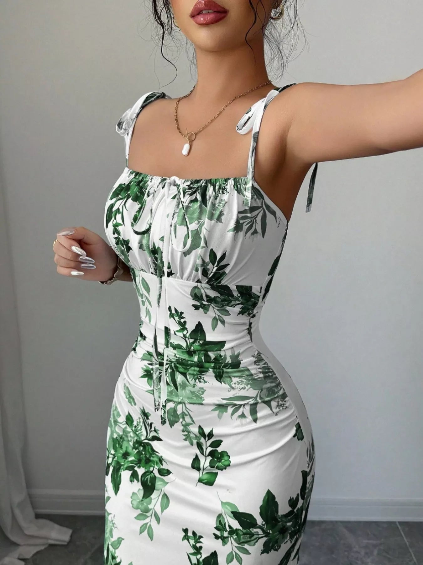 Printed tie strap slit maxi dress from Trendsi featuring a flowy design, bold print, and a high slit for a stylish, elegant look.