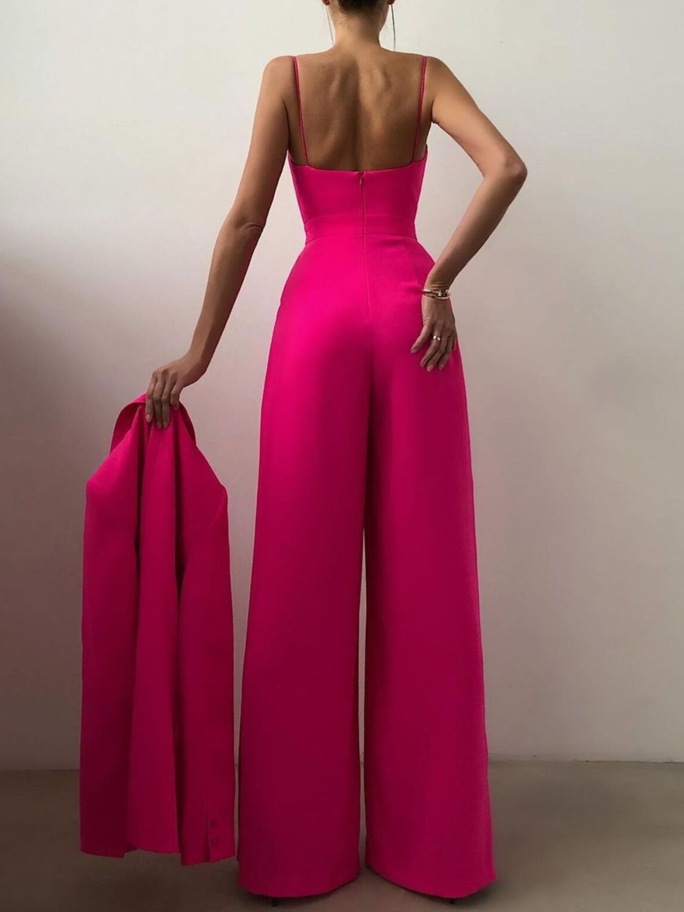 Wide-leg jumpsuit with spaghetti straps from Trendsi, featuring a stylish, flowy design perfect for casual or dressy occasions.