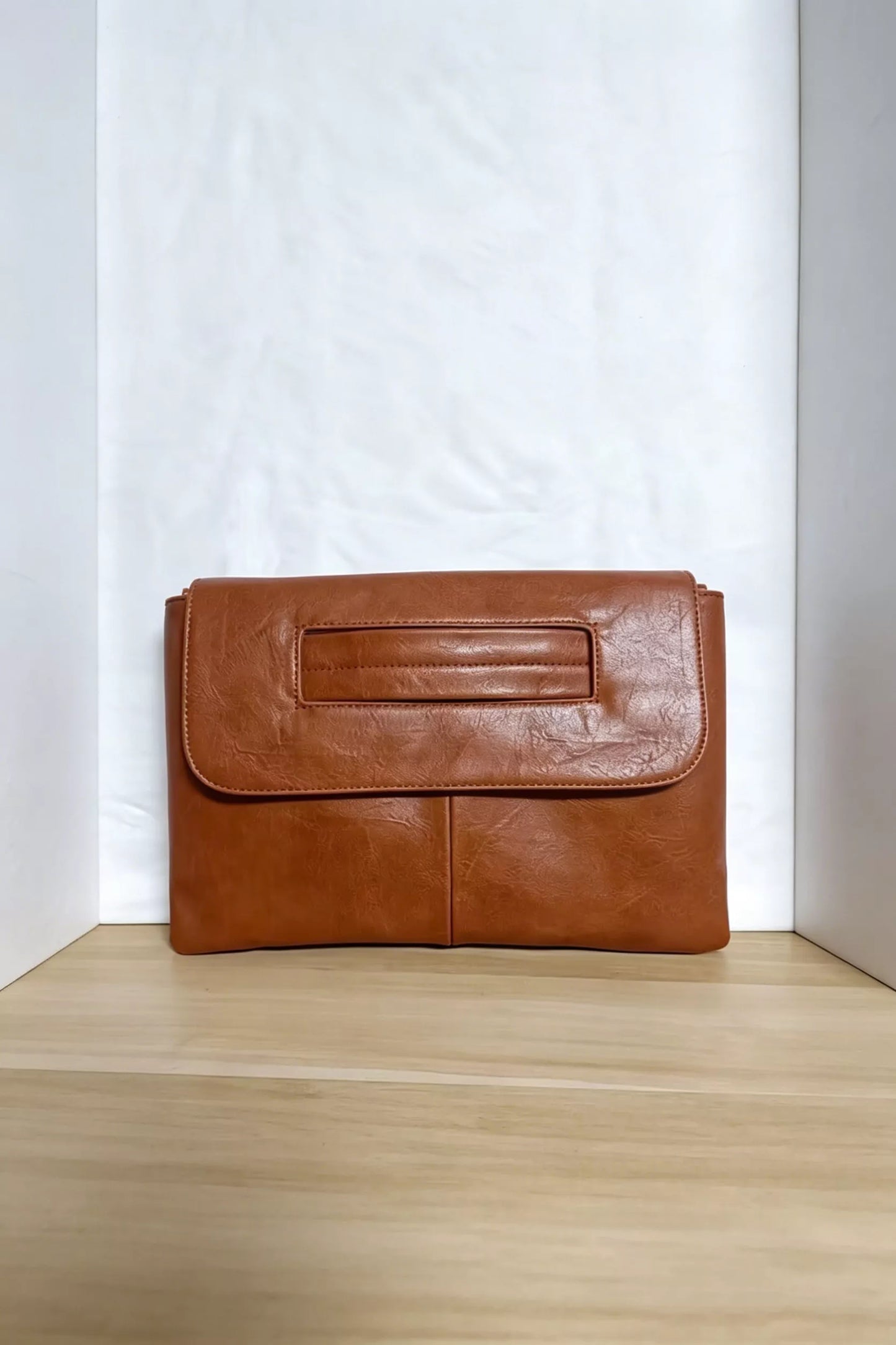Vintage style envelope clutch handbag from Trendsi, showing a sleek leather design with a fold-over flap and minimalist details.