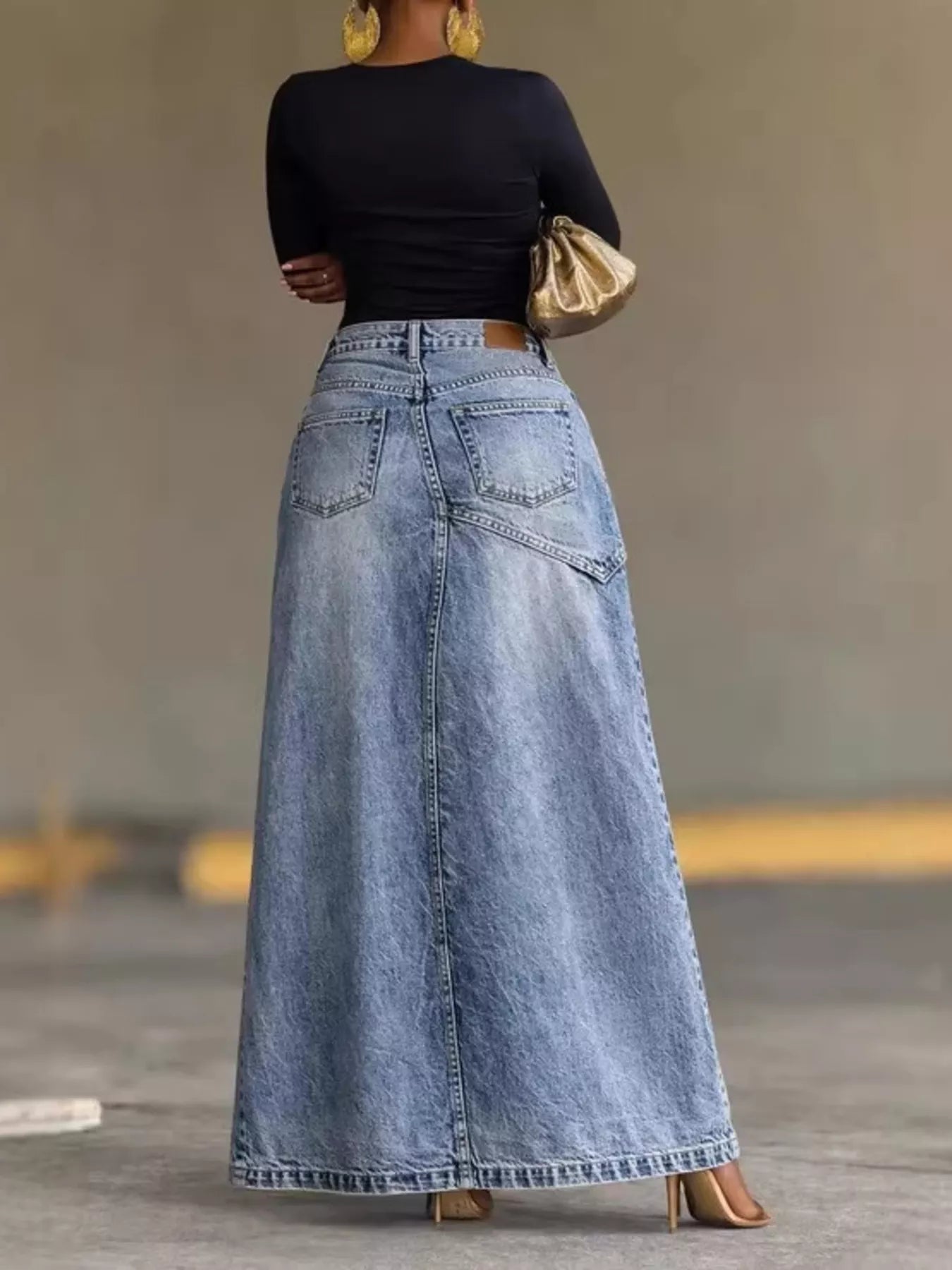 High-waisted slit denim skirt by Trendsi, featuring a classic blue wash, front slit, and fitted waist for a trendy casual look.
