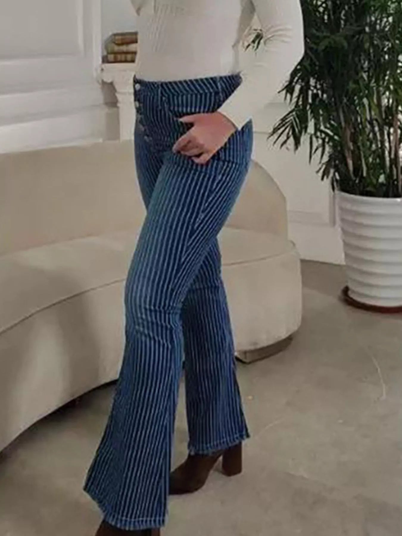 Striped button fly flare denim jeans from Trendsi featuring high-waisted design and bold vertical stripe pattern.