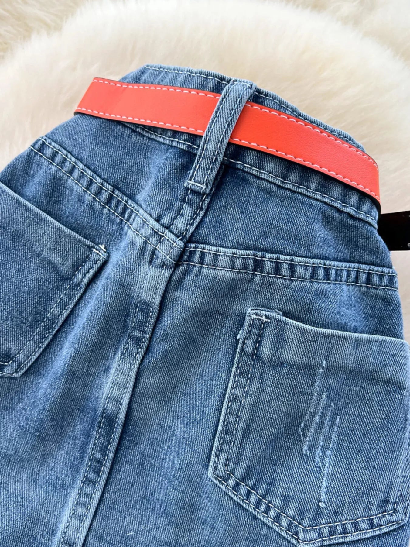Striped patchwork denim skirt from Trendsi, showing a stylish skirt with multicolored striped patchwork design and denim fabric.