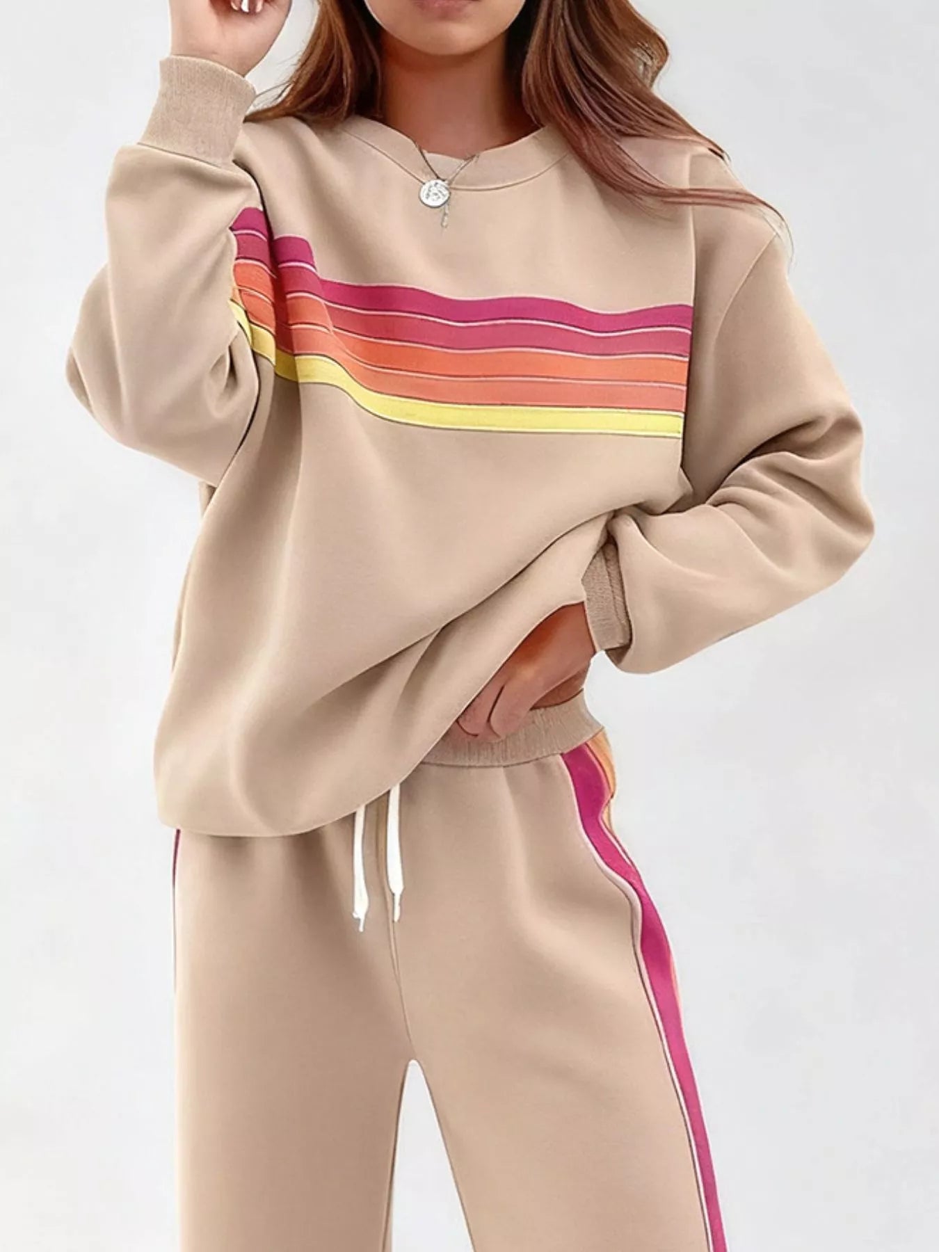 Striped round neck sweatshirt and pants set by Trendsi, featuring a casual, comfortable design with matching striped pattern.