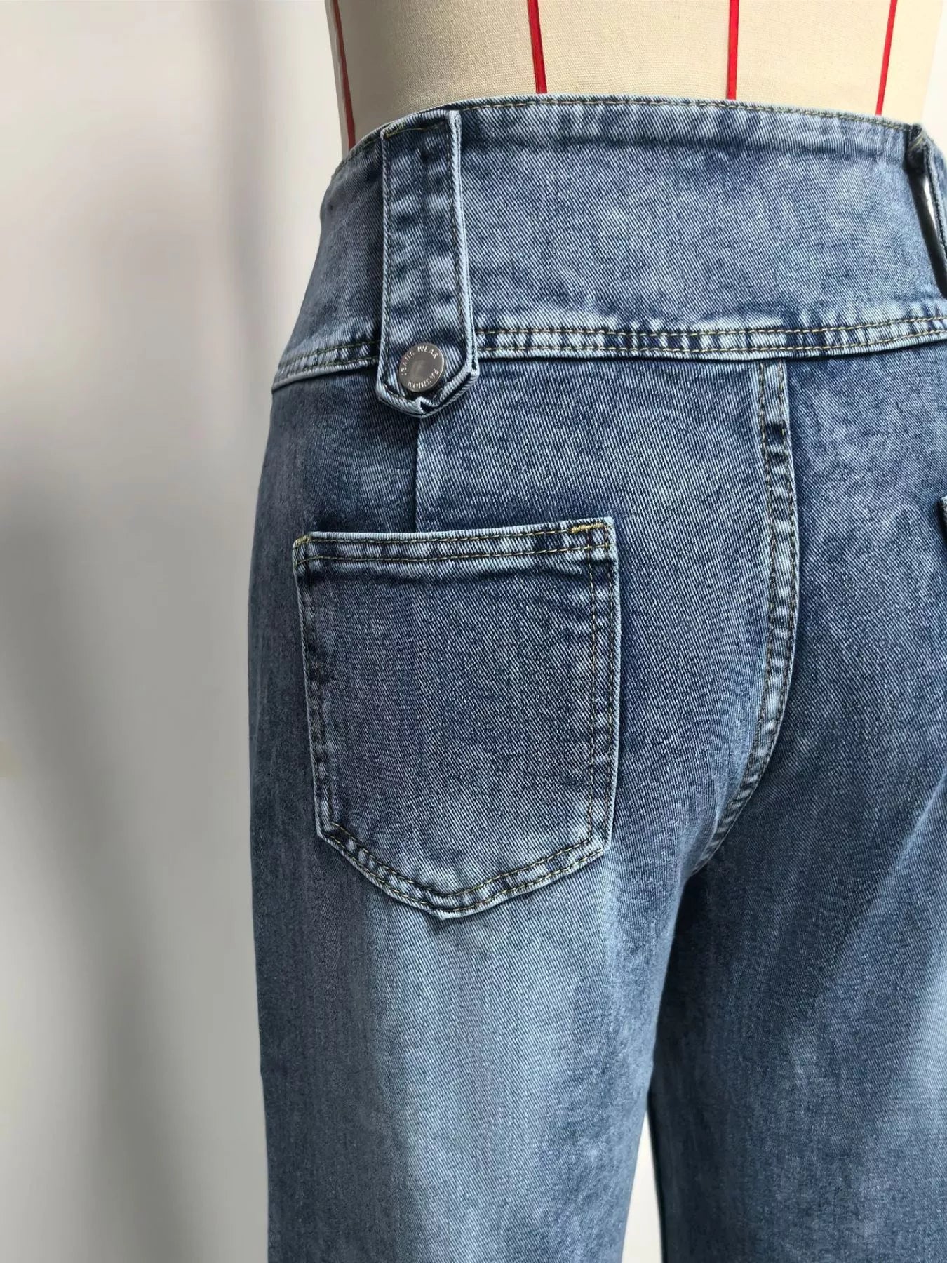 High waist denim wide-leg jeans with button decor from Trendsi, showcasing the relaxed fit and stylish design.