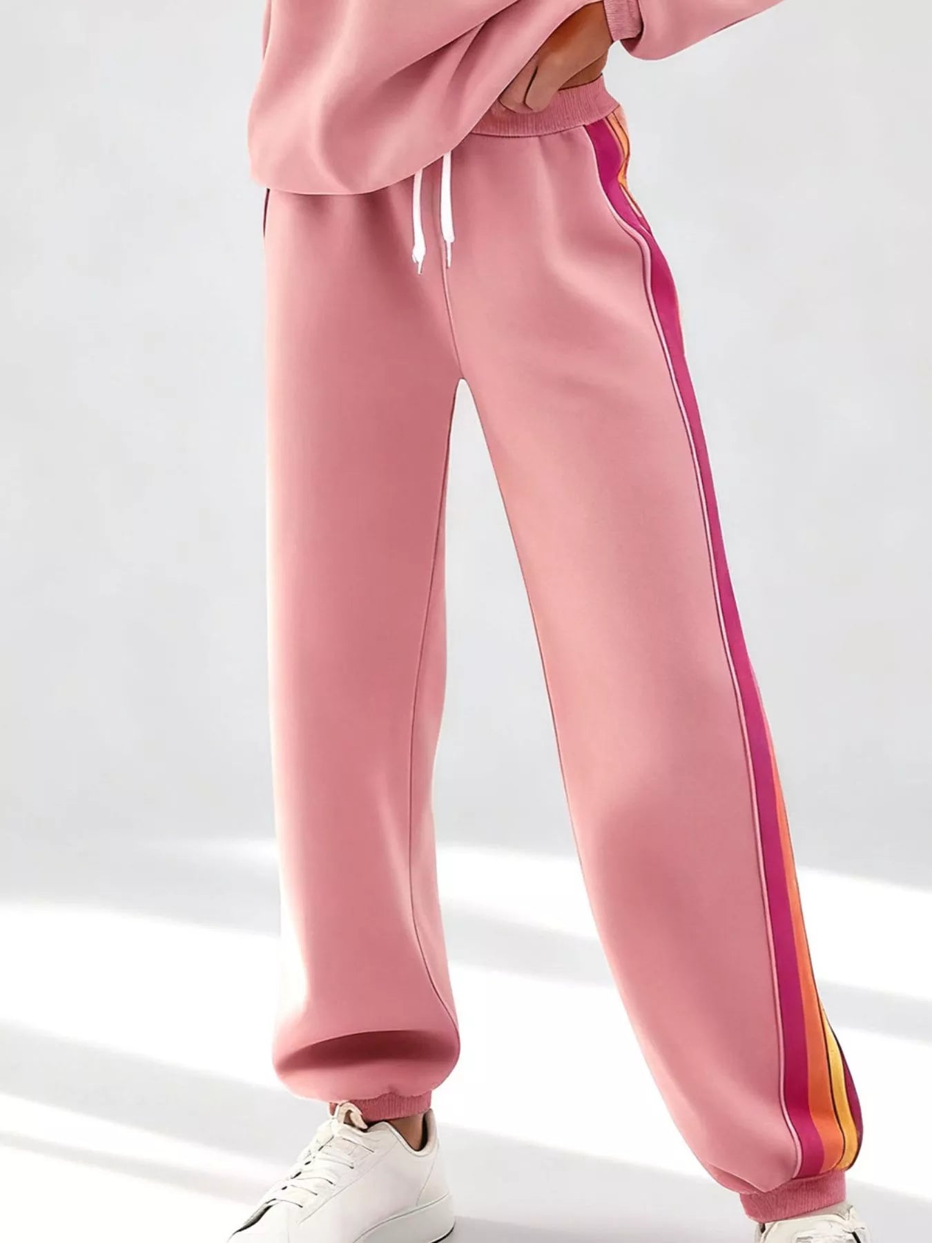 Striped round neck sweatshirt and matching pants set by Trendsi, casual loungewear with bold stripe pattern and comfortable fit.