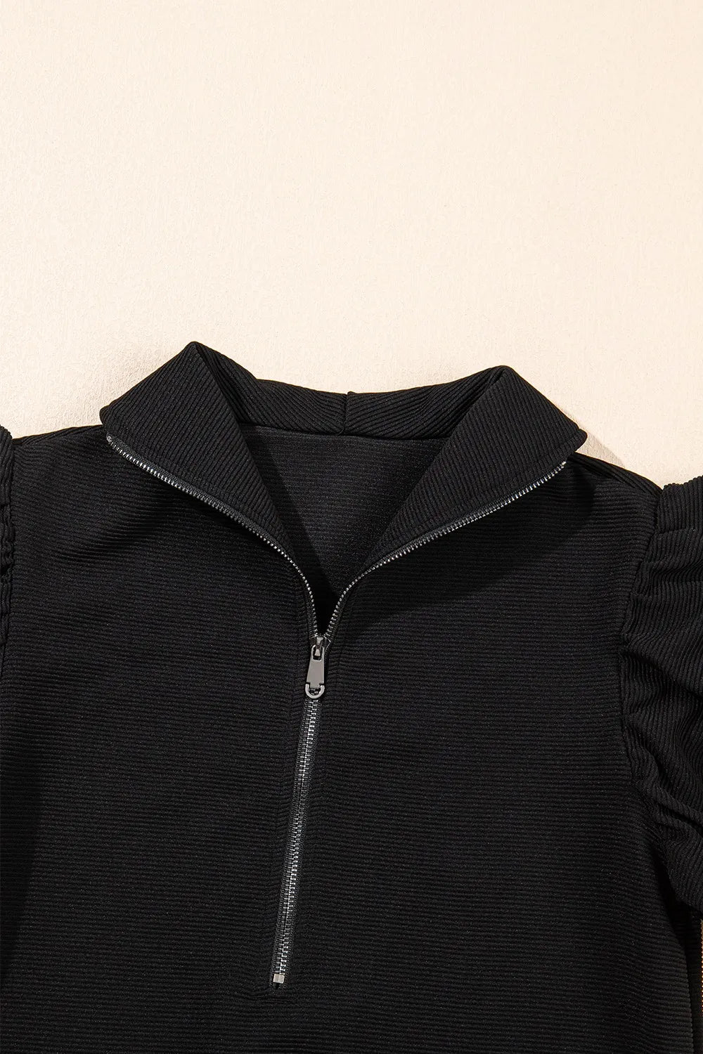 Textured ruffled sleeve zipped top and wide-leg pants set by Trendsi, displayed on a mannequin with neutral background.