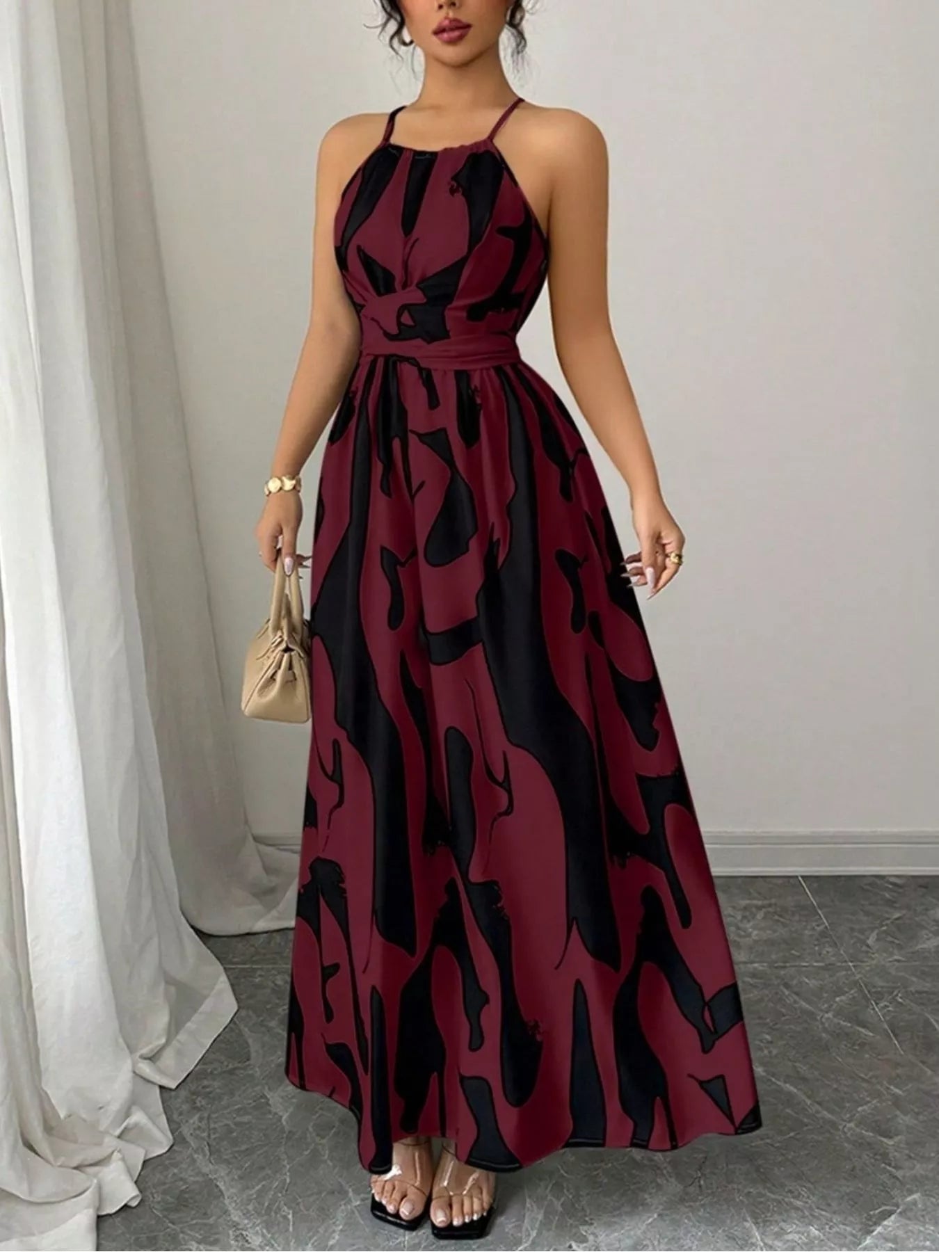 Abstract print halter neck maxi dress by Trendsi, featuring a flowing silhouette and bold colorful design.
