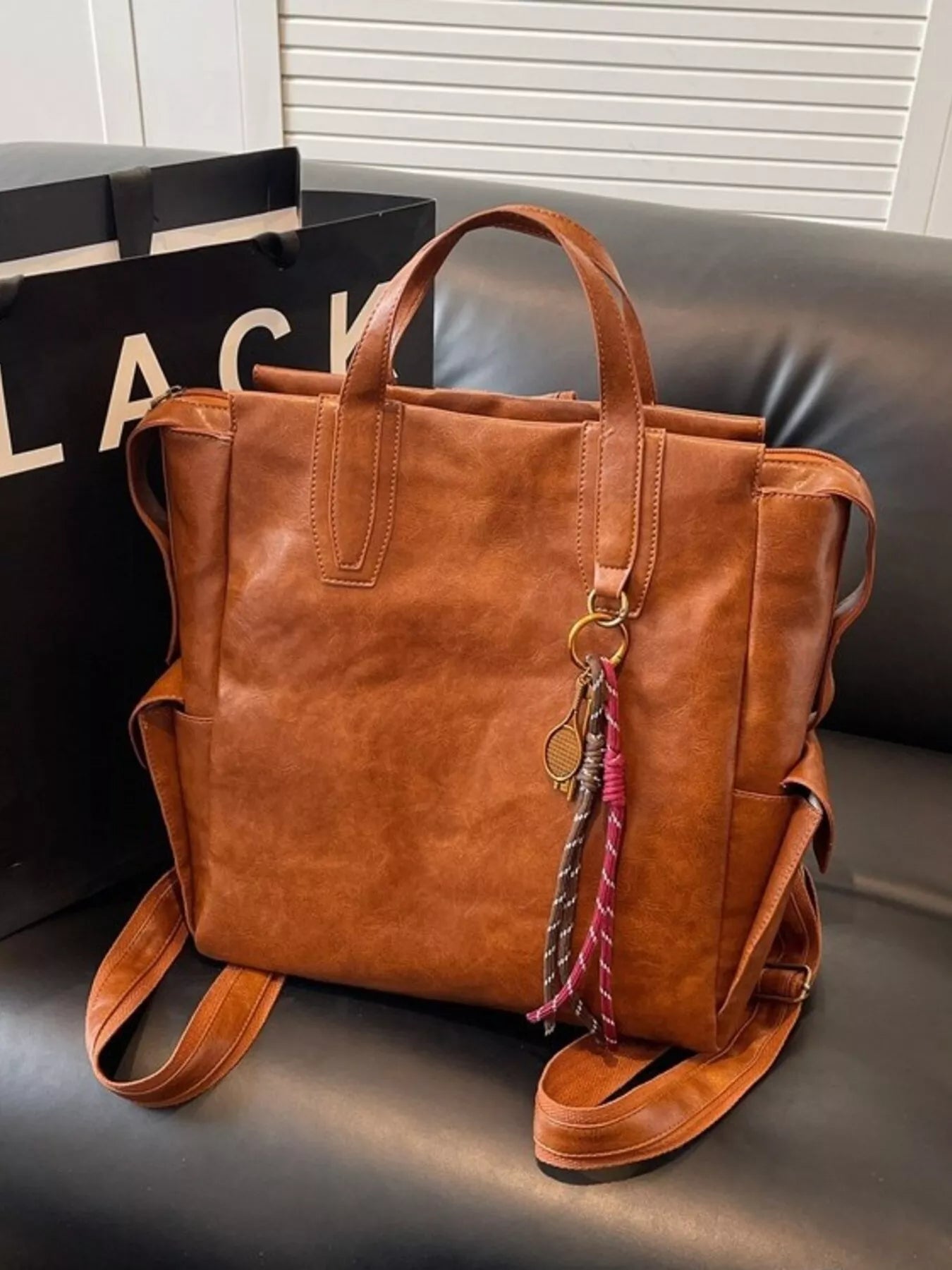 Vintage leather convertible backpack bag by Trendsi, showing a stylish, brown leather backpack with adjustable straps and top handle.