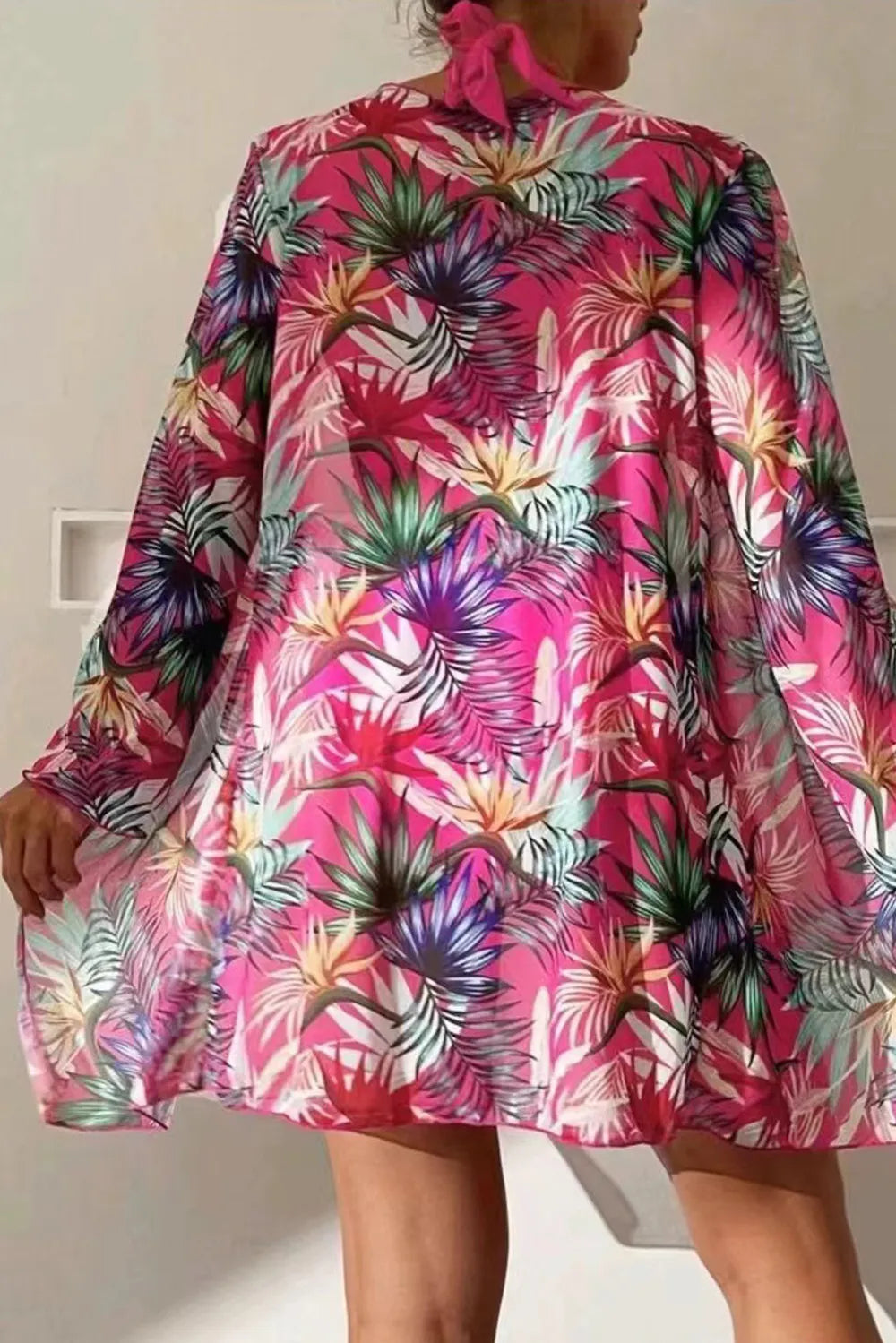 Printed halter neck three-piece swimwear set by Trendsi featuring a stylish swim top, bottoms, and cover-up in vibrant print.