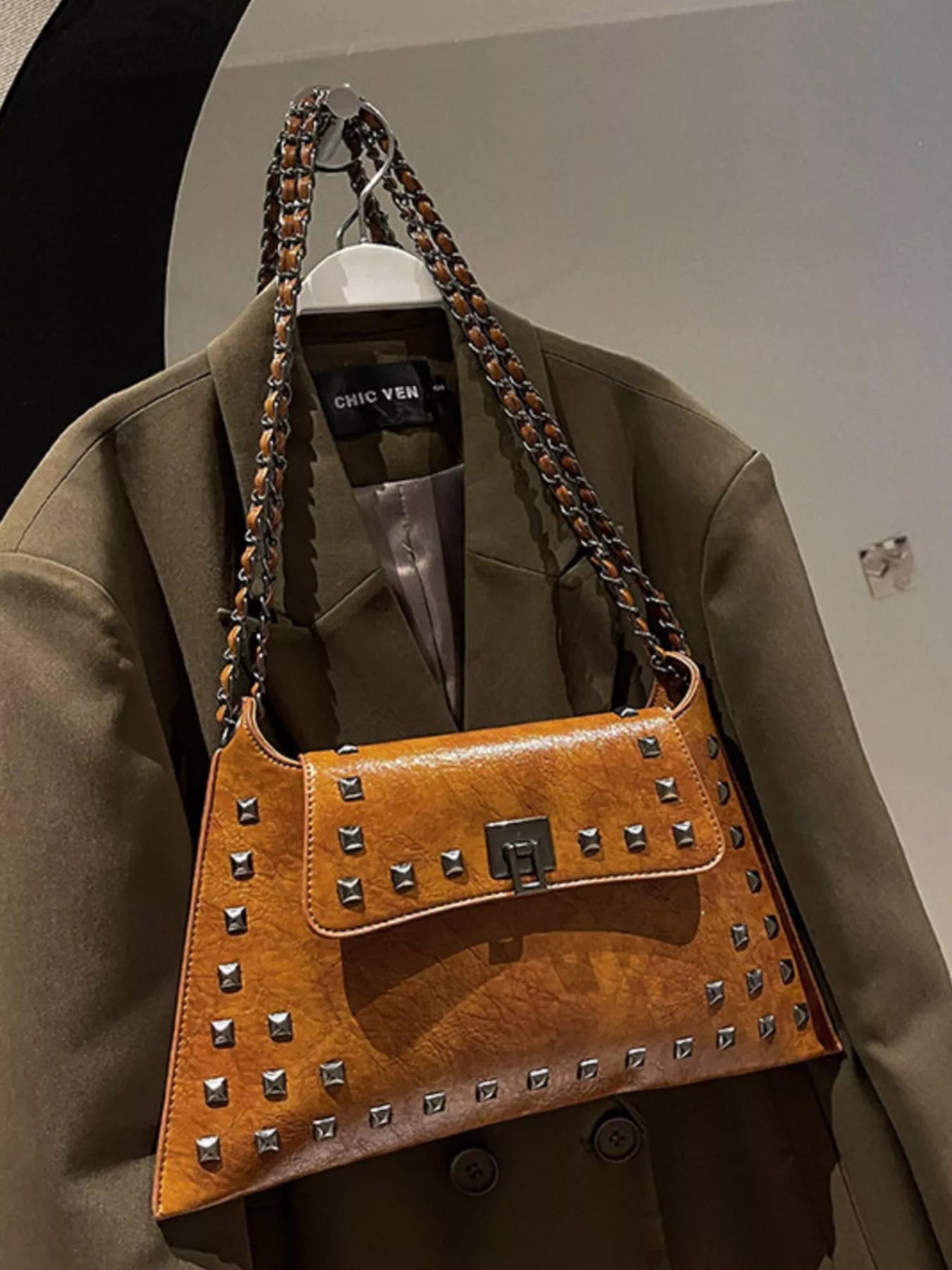 Black studded flap chain shoulder handbag with chain strap and trendy design, ideal for stylish everyday use.