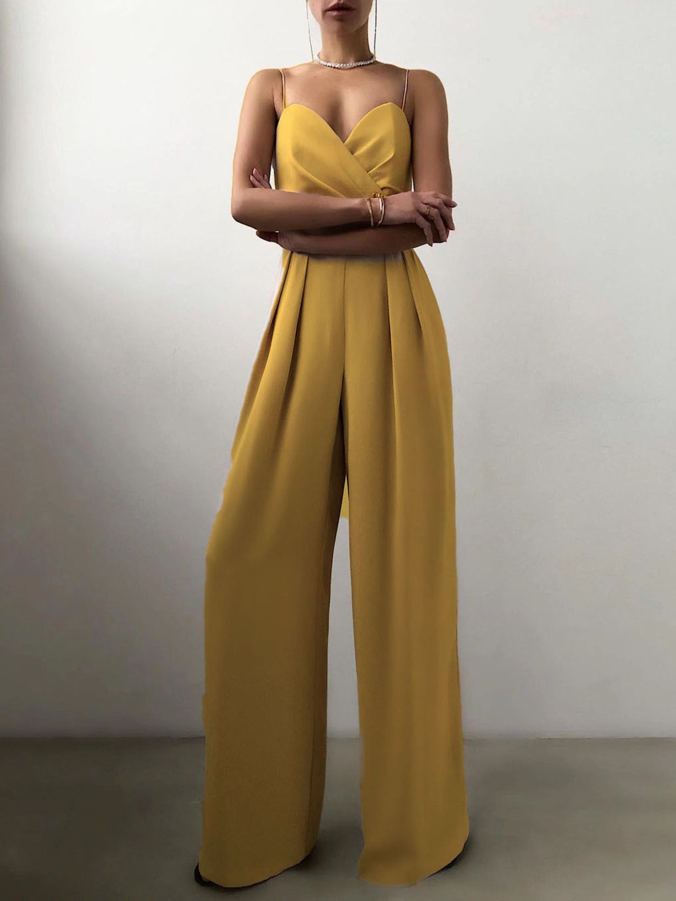Trendsi spaghetti strap wide-leg jumpsuit featuring a fitted bodice and flowing pant legs, perfect for casual or dressy occasions.