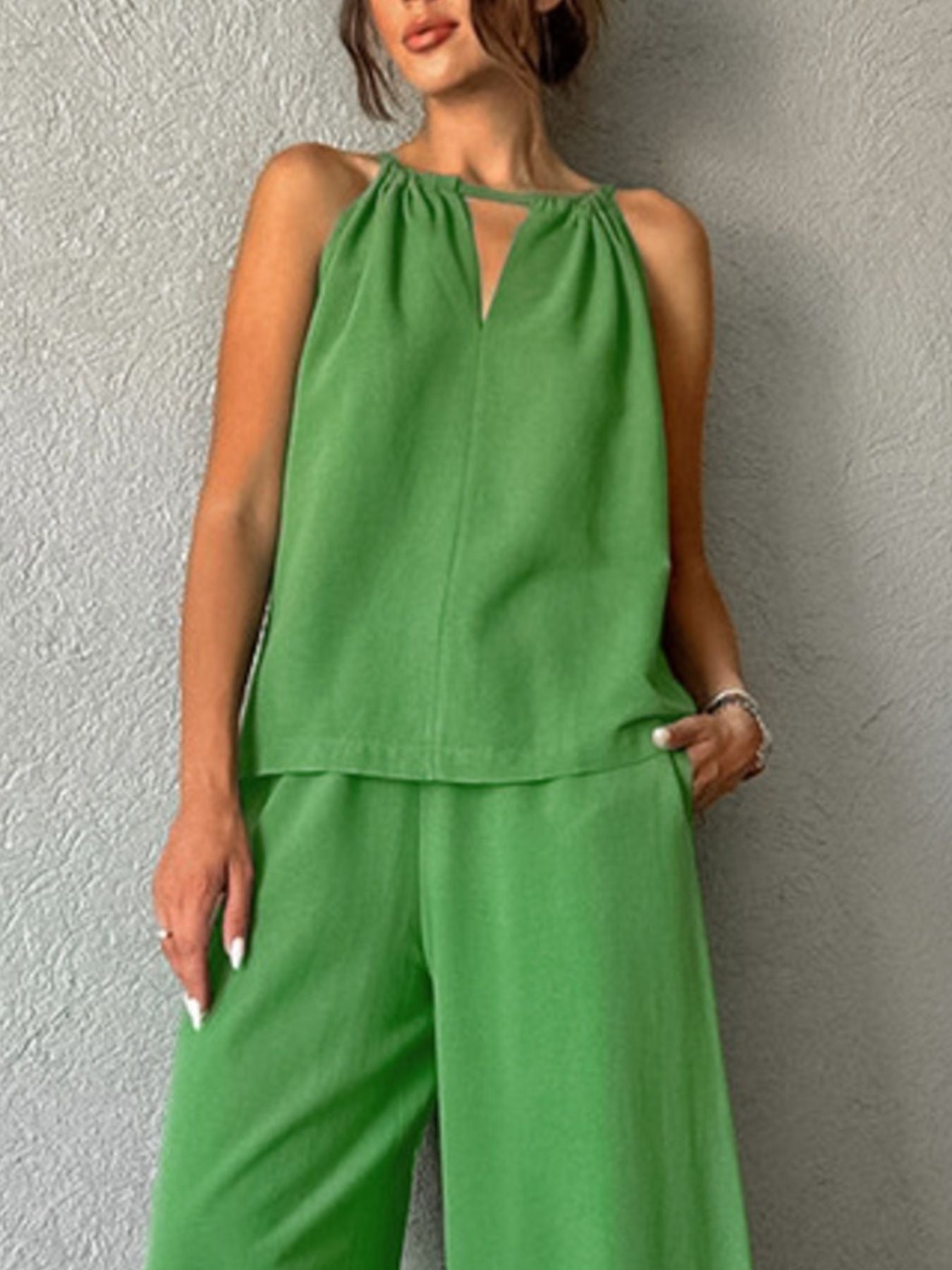 Trendsi cutout tank top and wide-leg pants set, featuring a stylish sleeveless top with cutout details and flowing wide-leg trousers.