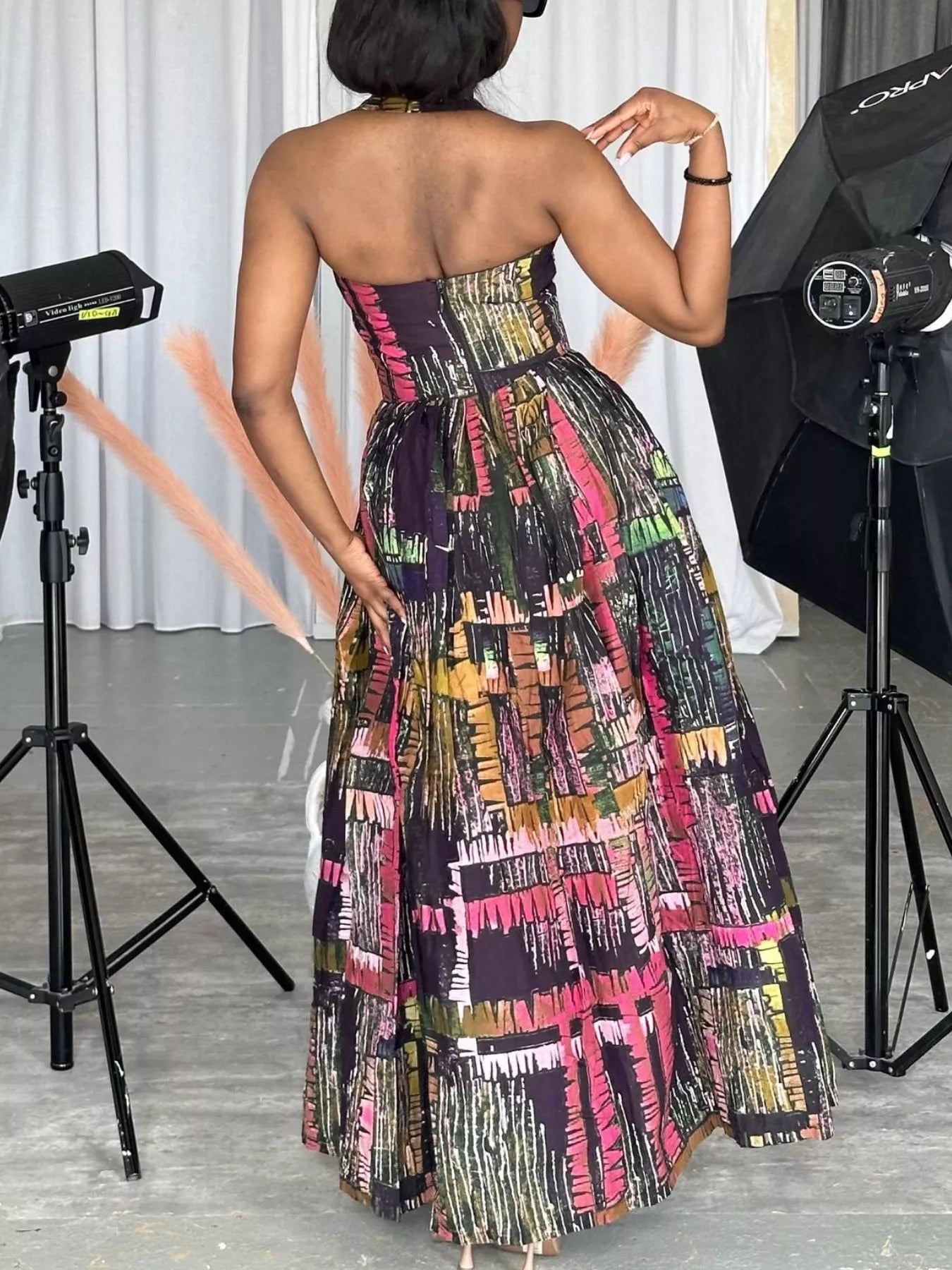 Abstract print halter neck maxi dress by Trendsi featuring flowing fabric and bold, colorful patterns, perfect for summer wear.