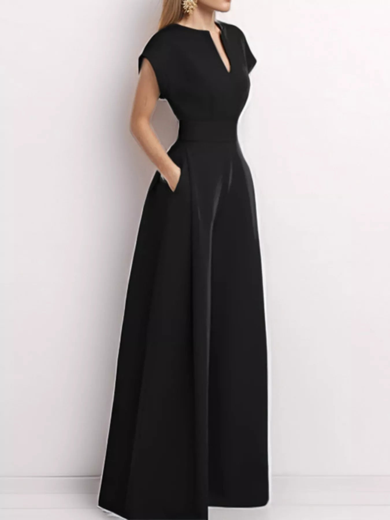 Notched wide leg jumpsuit by Trendsi featuring a stylish design, with a fitted bodice and flowing wide leg pants.