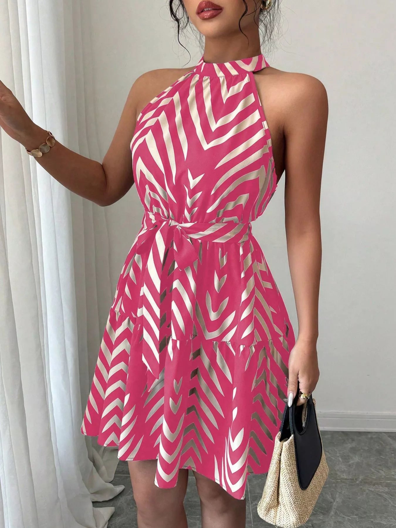 Zebra print halter neck dress with tie waist and ruffle hem from Trendsi, featuring bold black and white animal print fabric.
