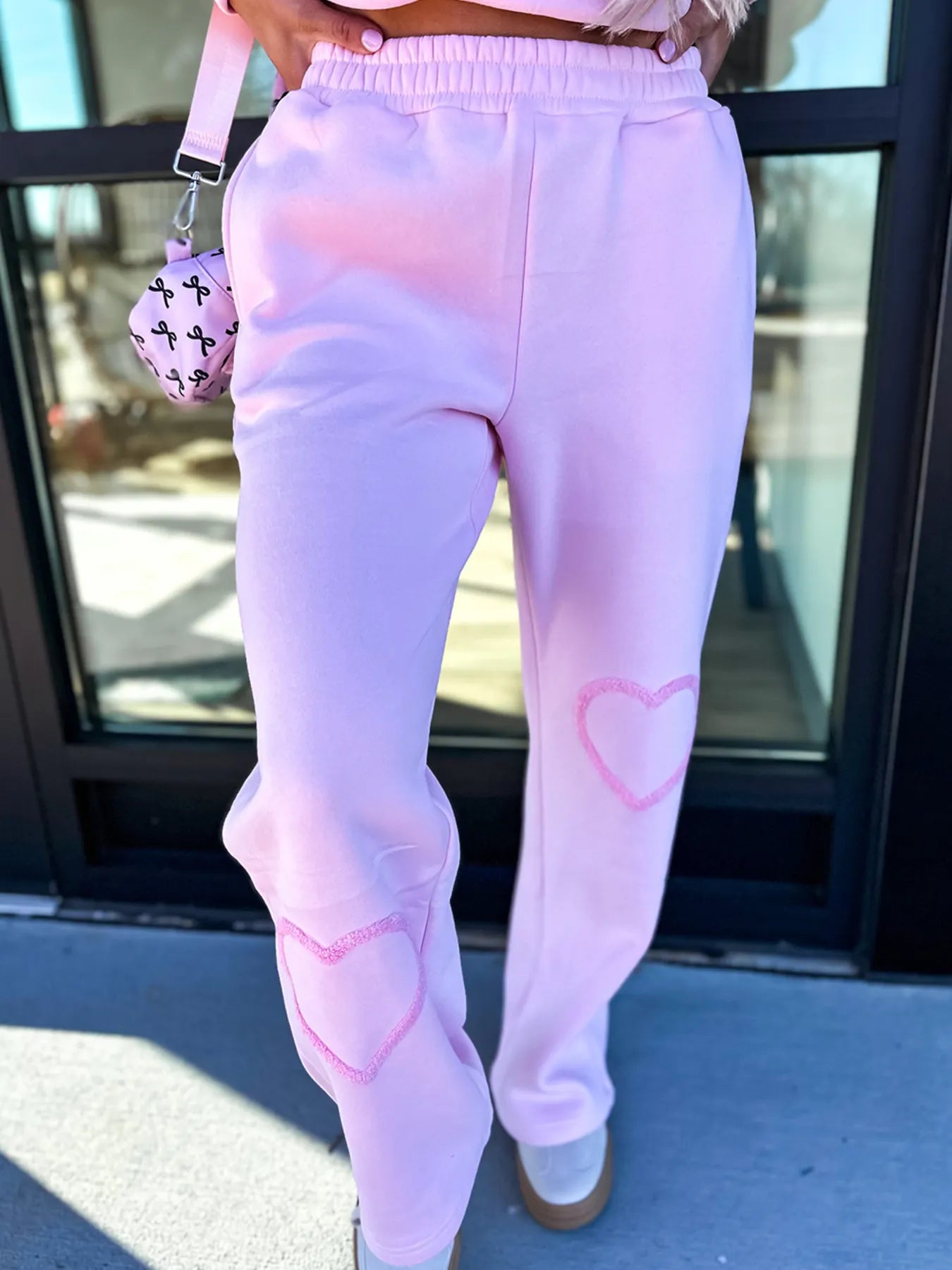 Trendsi round neck heart print top and matching pants set for women, featuring a casual, comfortable design with a stylish heart motif.